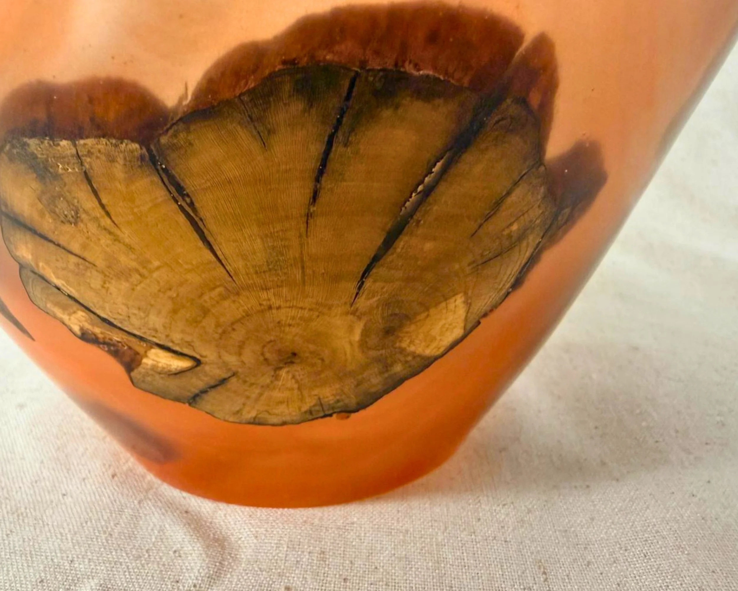 Close-up of the exterior showing clustered wood structure and darker veining in amber epoxy.