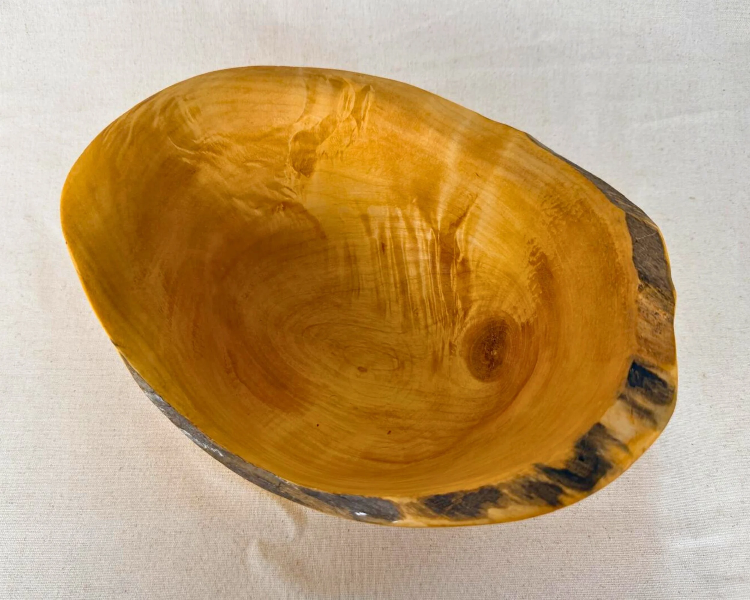 Top down view of reclaimed pine natural edge vessel showing oval opening and interior grain.