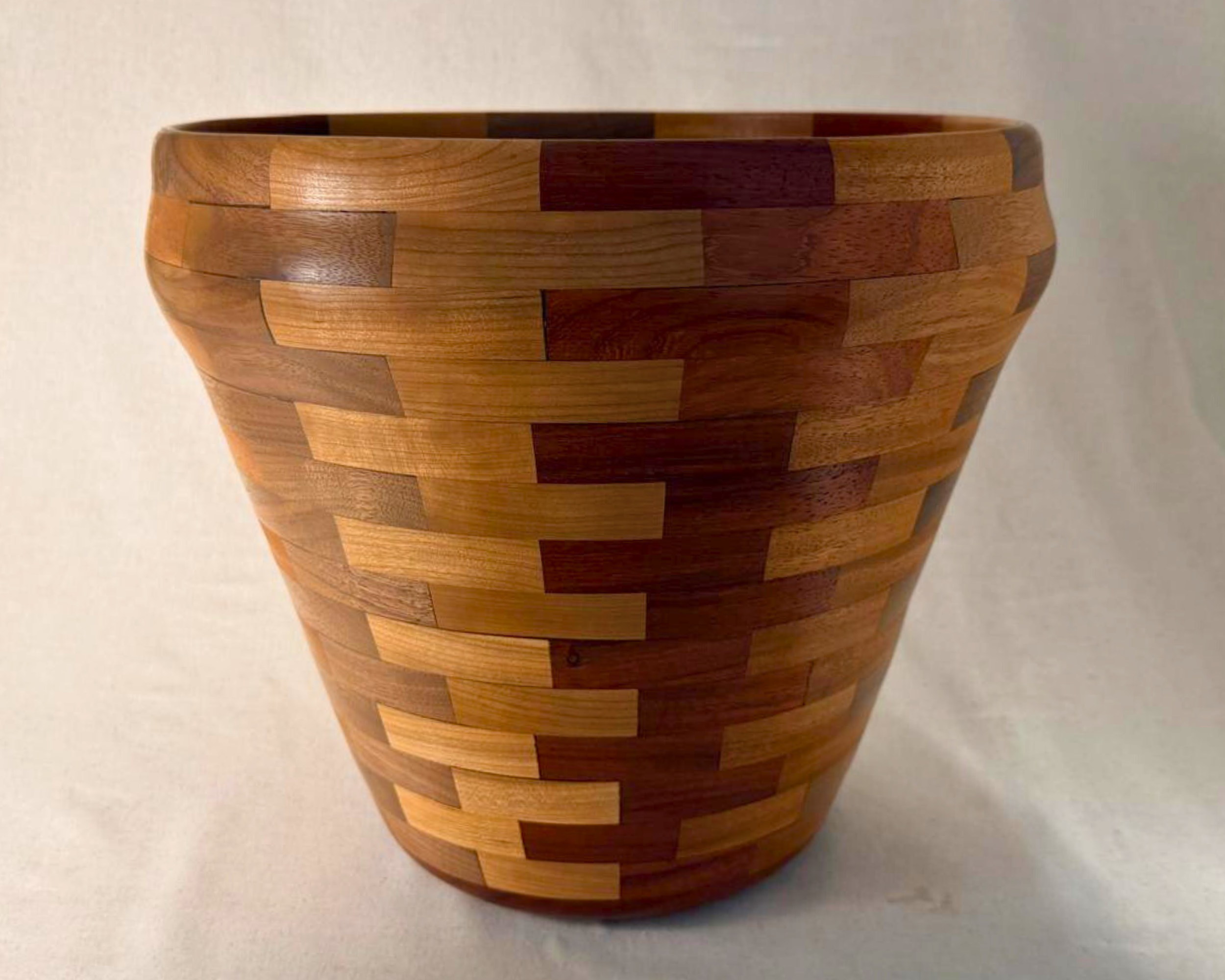 Full view of large segmented wood vessel centered on neutral background showing overall scale and silhouette.