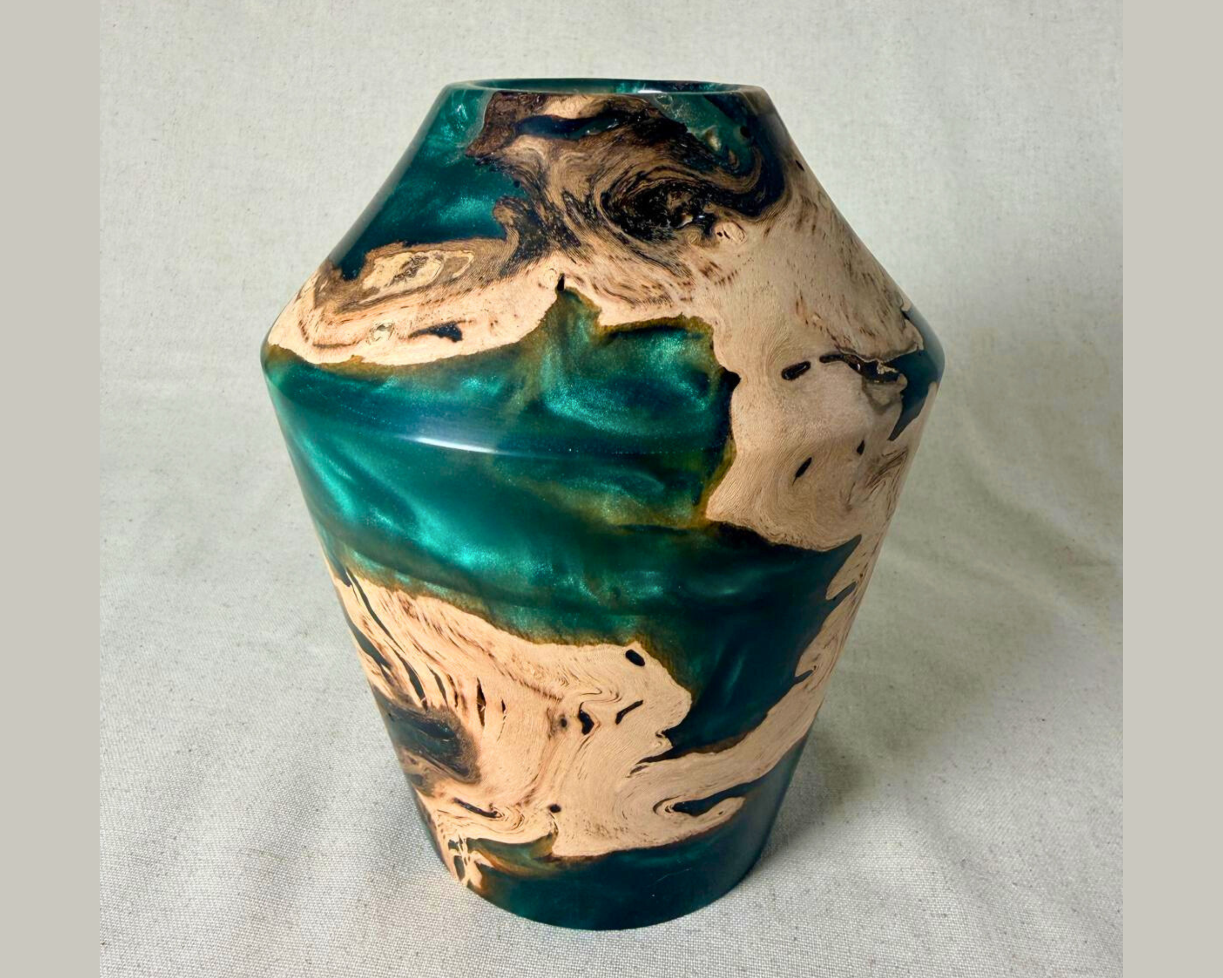 Front-facing view of driftwood and green epoxy vessel with strong vertical profile, pale driftwood inclusions, and saturated green resin across the center band.