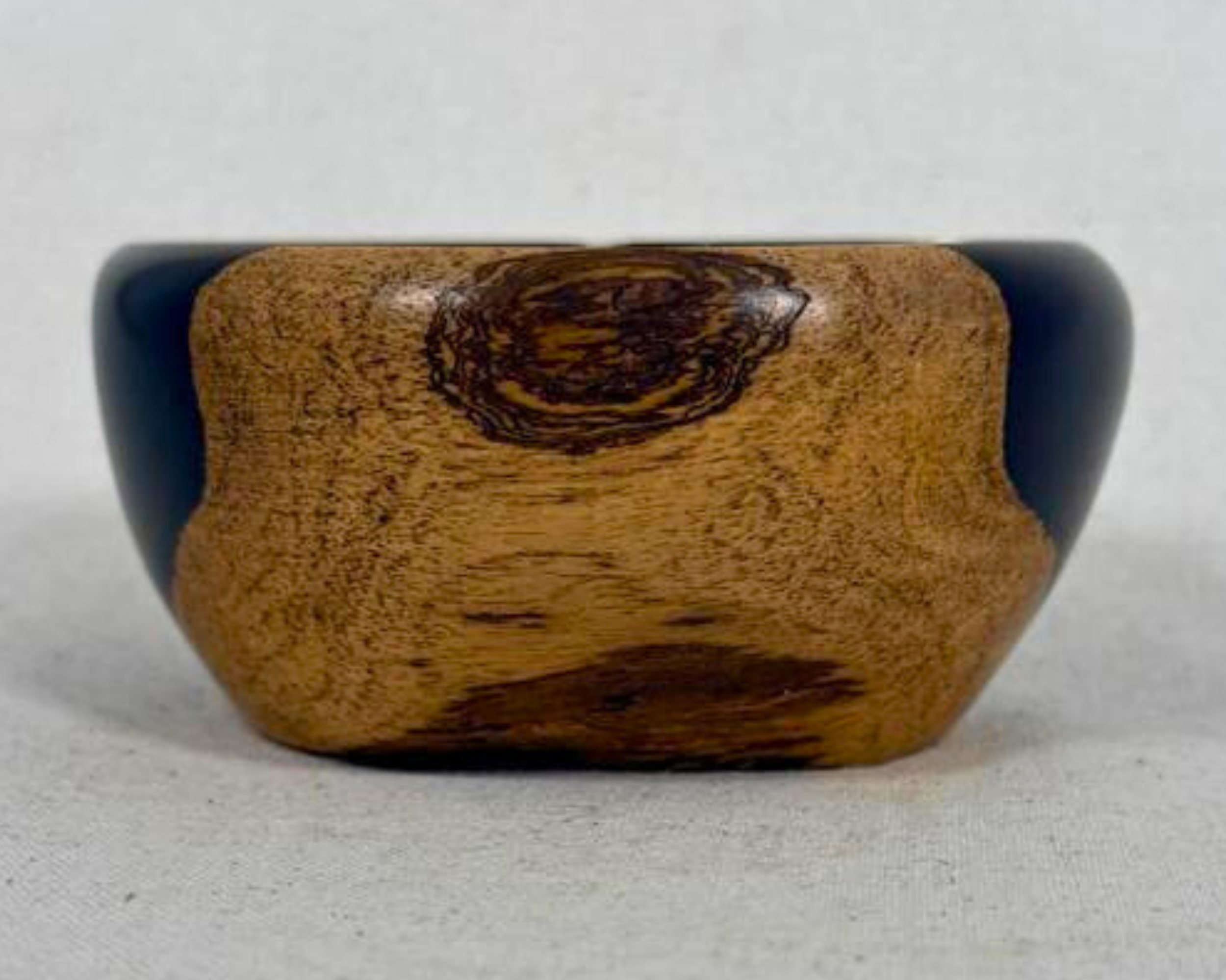 Straight-on profile view of the African Blackwood bowl showing the central grain figure and compact sculptural shape.