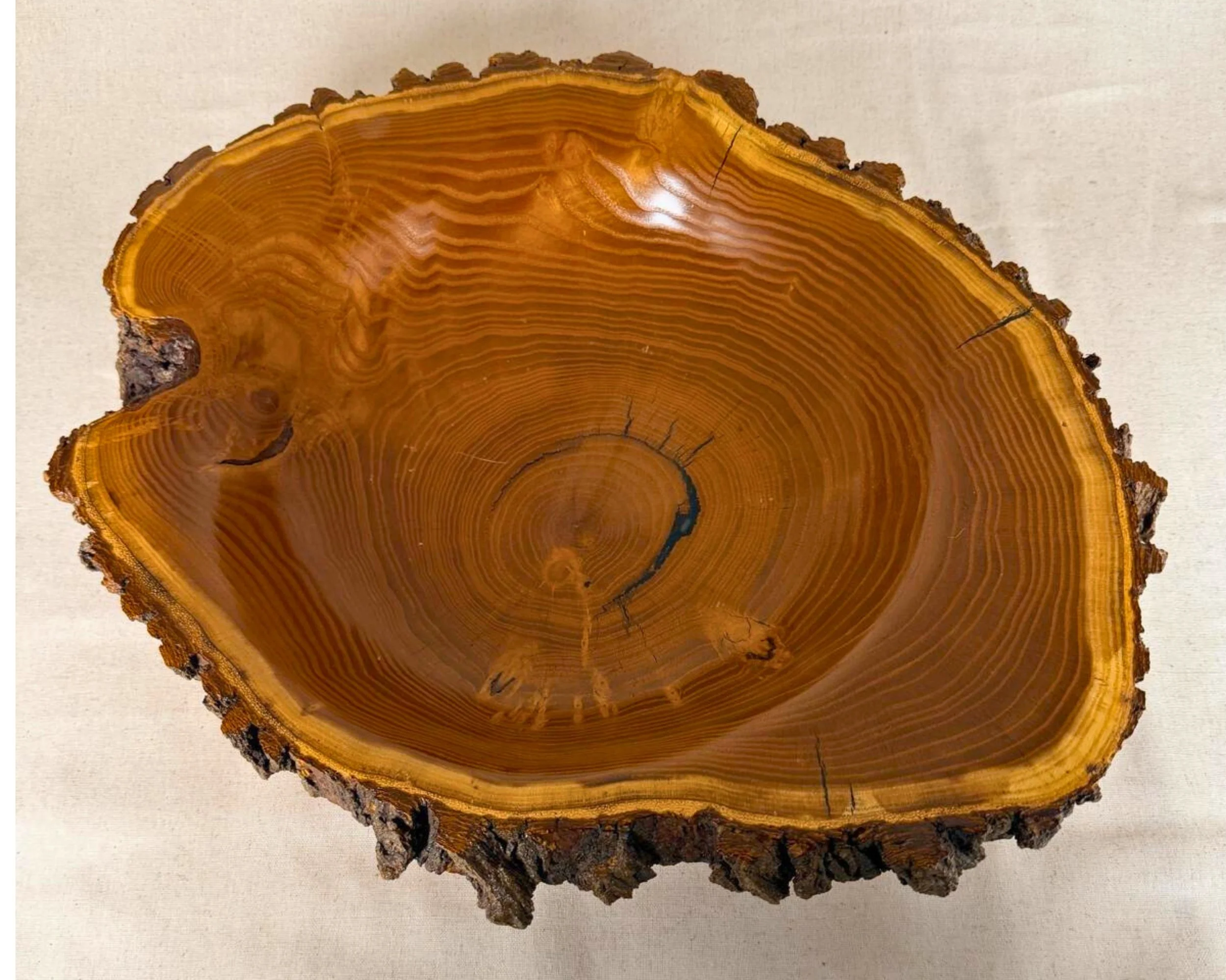 Top view of mulberry live-edge bowl showing wide grain pattern and natural bark rim