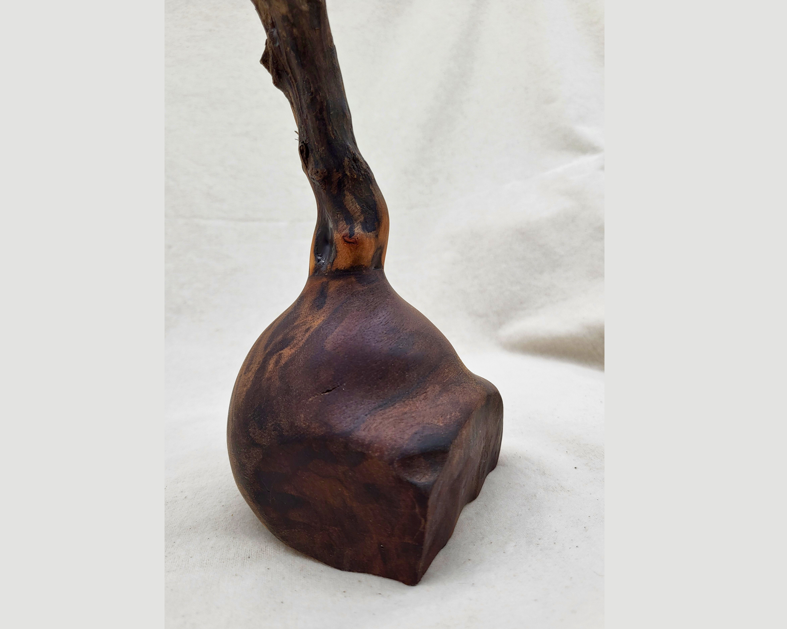 Alternative angle of the claro walnut base on a Treverk Woodturning sculpture, showing the dramatic figure of the claro grain and the faceted, boulder-like silhouette in matte finish. Sculptural wood art.
