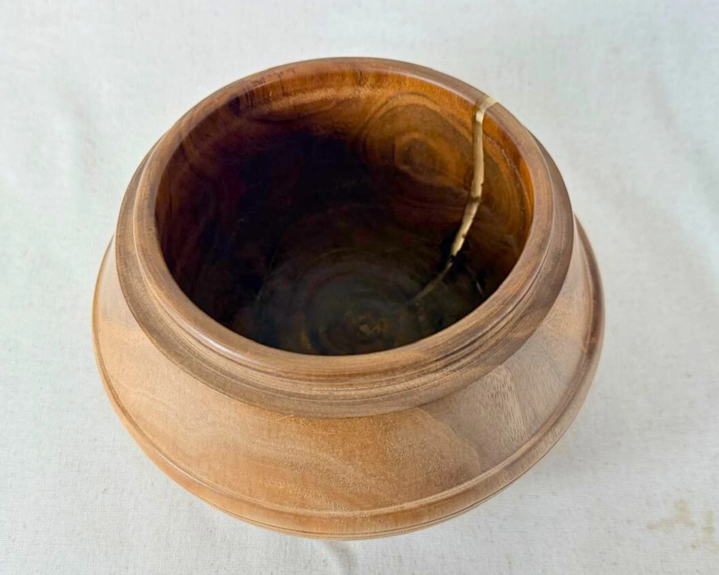 Top-down view into walnut bowl showing interior grain and the epoxy accent line near the rim.