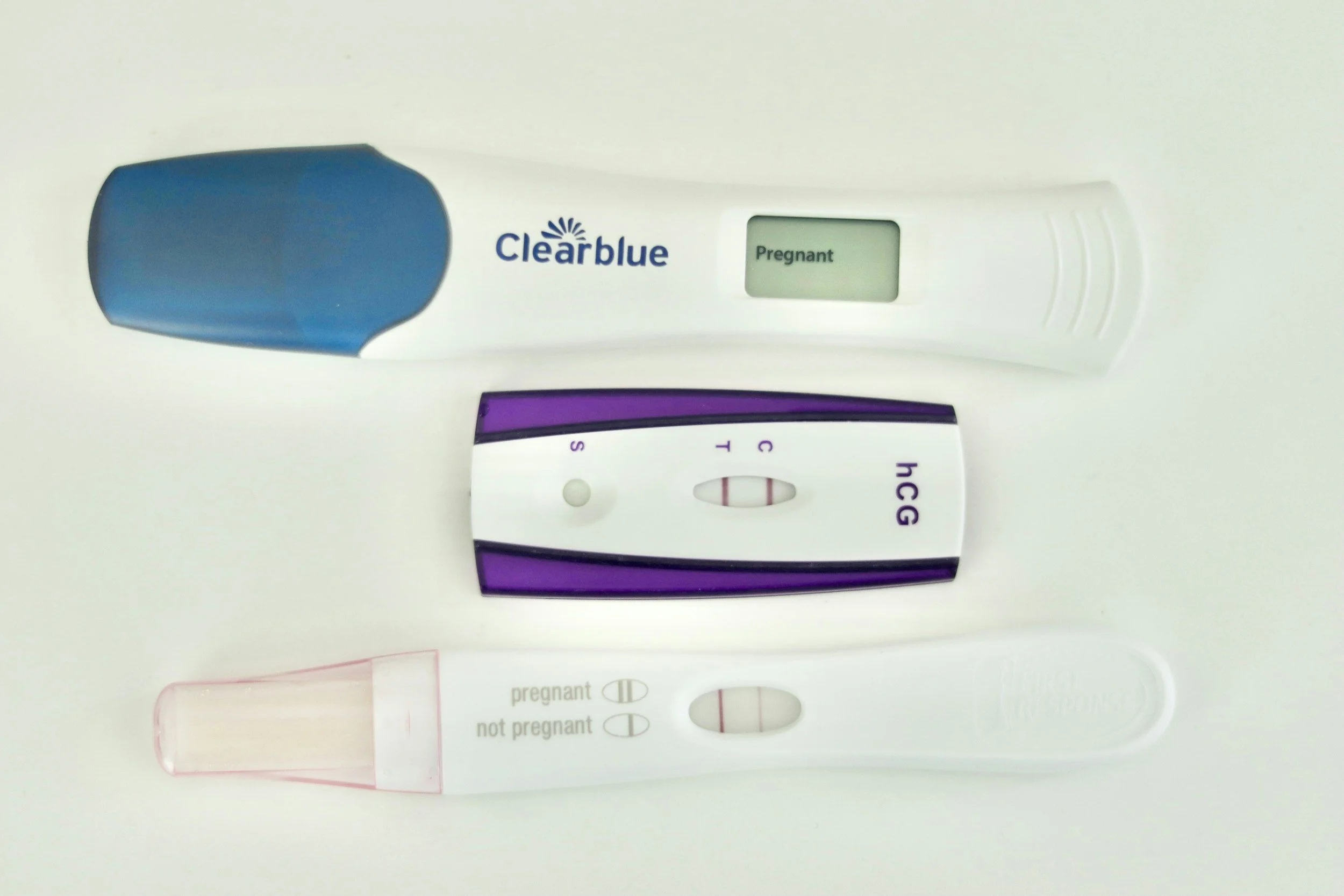 Three home pregnancy tests with positive results.