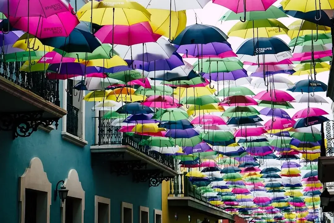 Colorful umbrellas hanging above a street in Puerto Rico, creating a vibrant canopy.