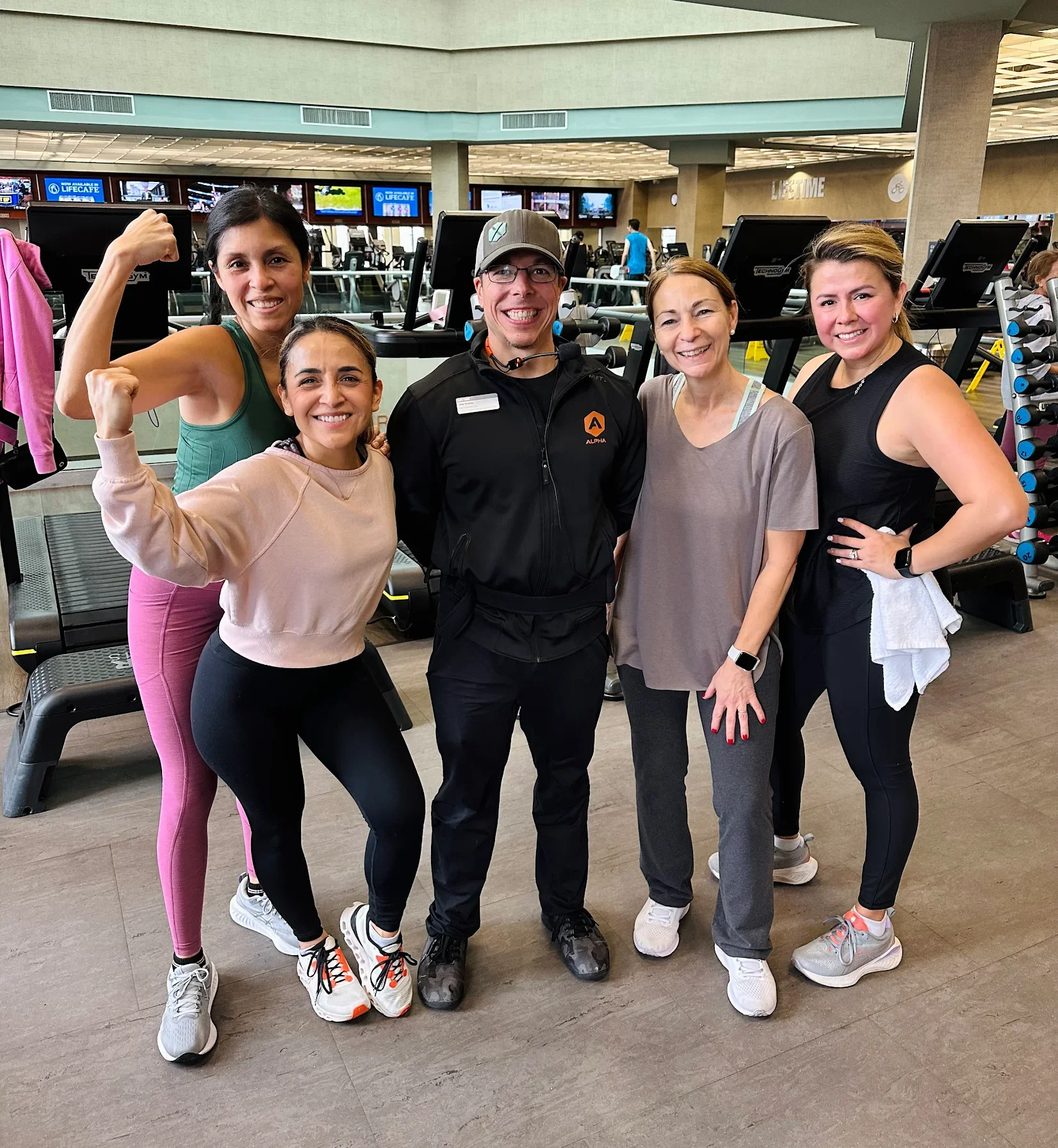 Joey Personal Trainer Life Time Easton with women clients smiling at the camera