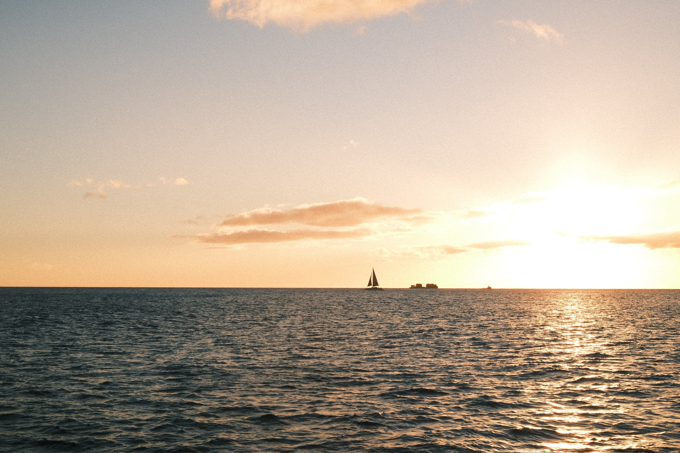 Waikiki sunset cruise experience aboard a Honolulu boat tour along the Pacific coastline.