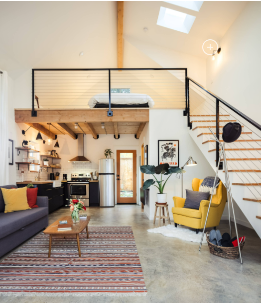 ADU conversion with bed, sofa, and compact kitchen layout