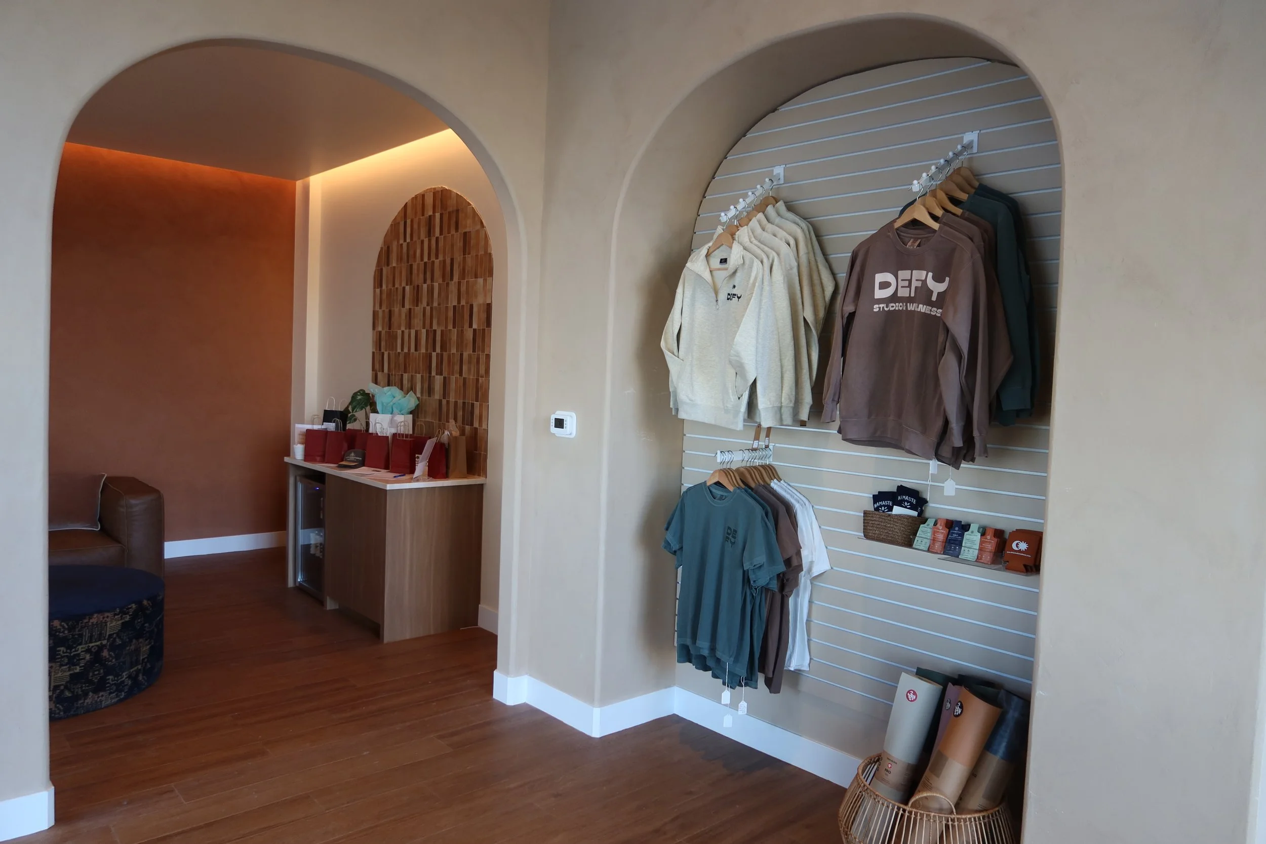 Retail display featuring apparel and wellness accessories at DEFY Studio & Wellness.