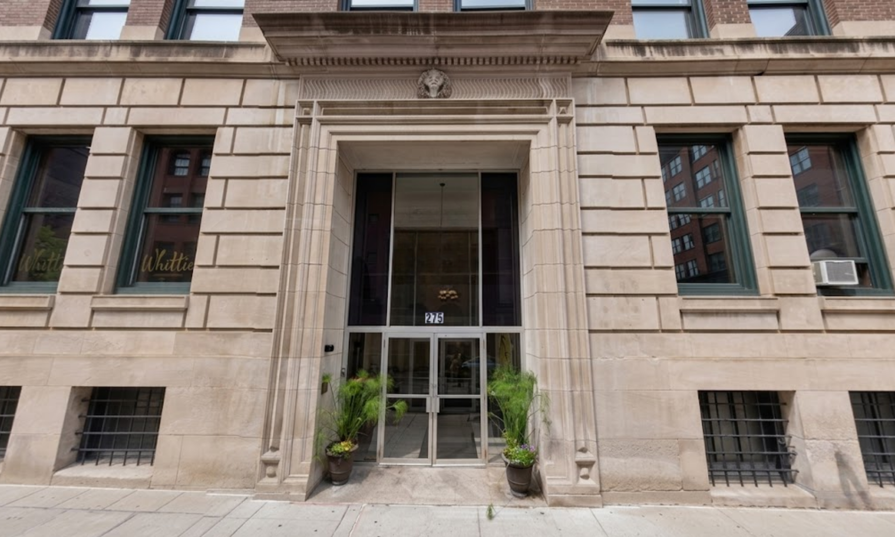 Historic office building lobby in downtown Saint Paul, Minnesota, featuring elevator access and a welcoming entrance to Zap House electrolysis hair removal studio.