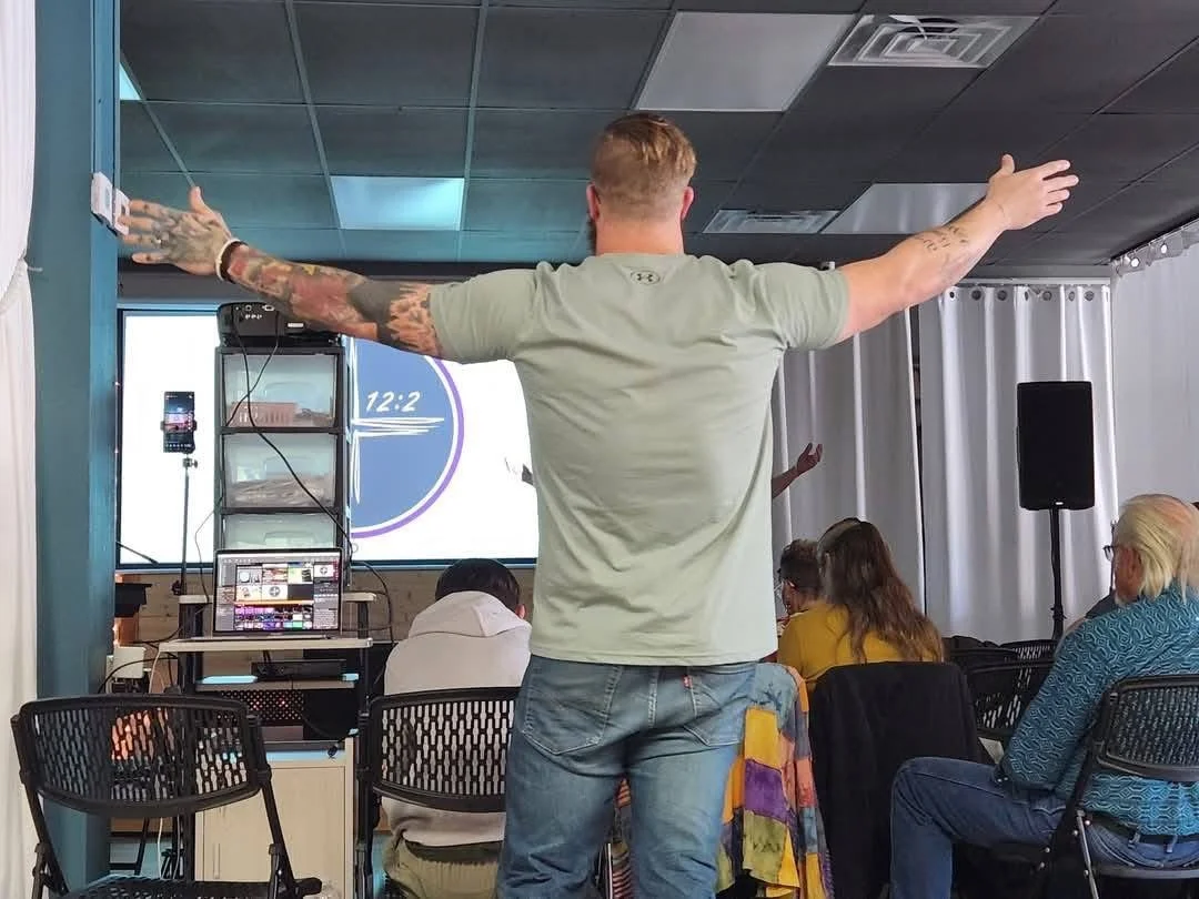 A man worshiping at 12:2 Fellowship in Mountain View, AR.