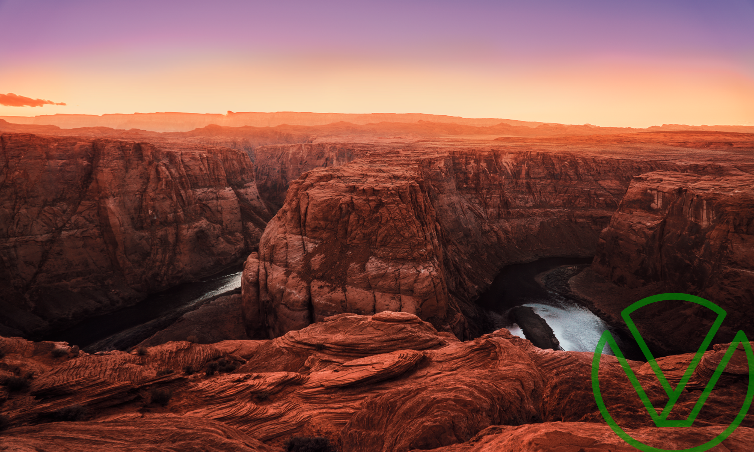 Scenic view of a red rock canyon at sunset, with layered cliffs and a winding river below, symbolizing resilience and strategy.