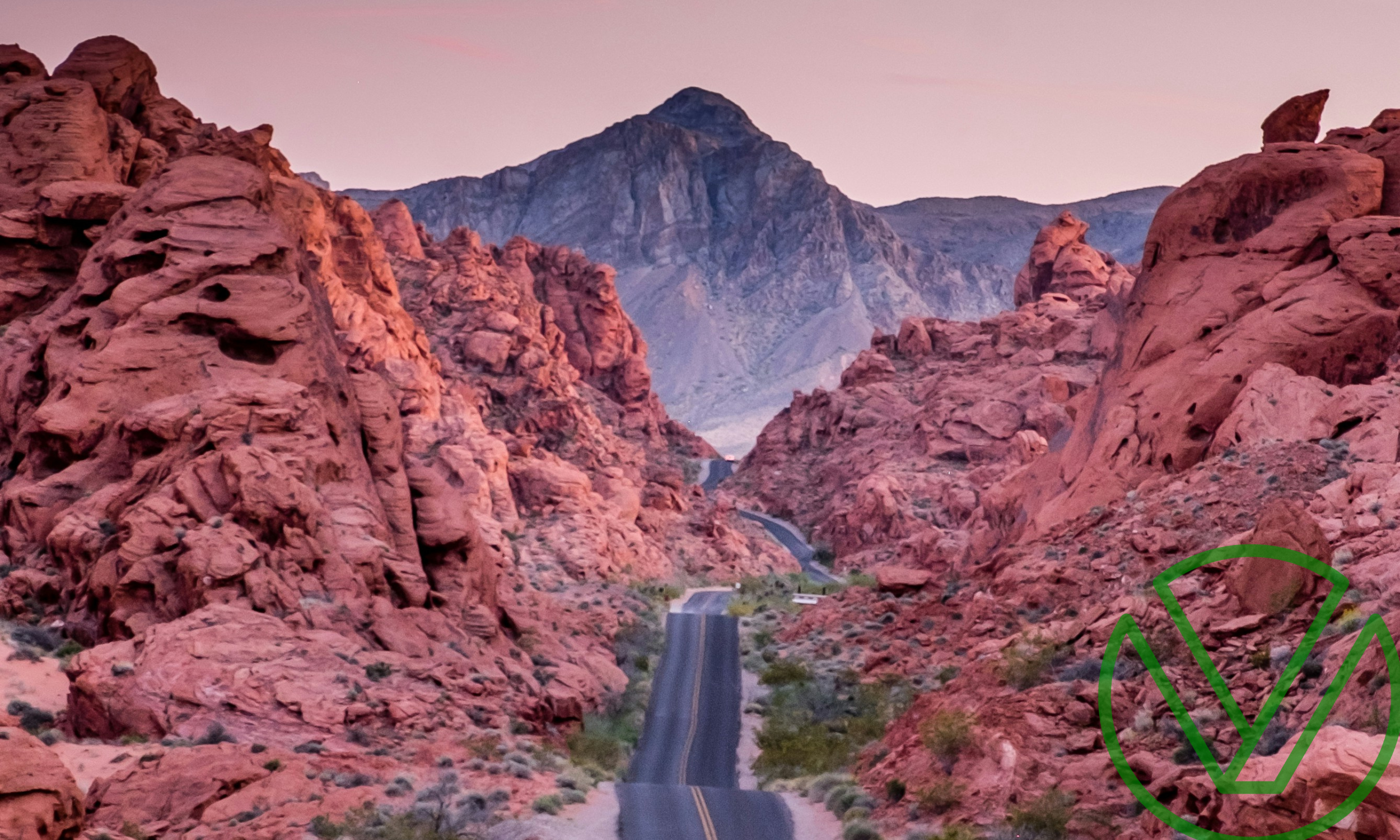 A road cutting through red rock formations at sunset, symbolizing navigating significant changes, such as income fluctuations, and their impact on tax liability.