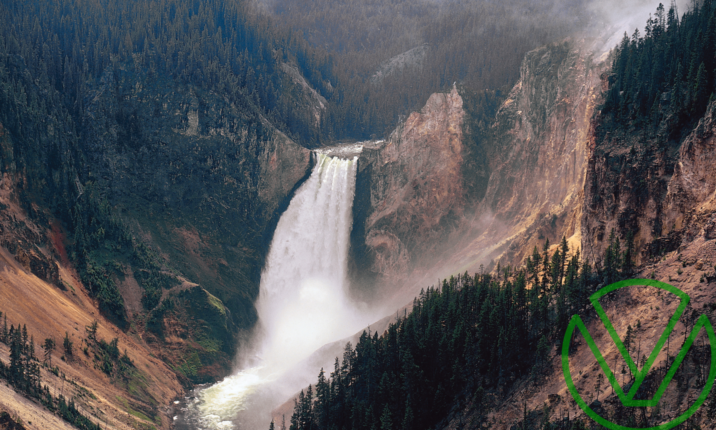 An awe-inspiring waterfall cascades into a rocky canyon surrounded by a dense forest, symbolizing the natural flow and optimization of resources, akin to unlocking potential tax savings through accelerated depreciation strategies.