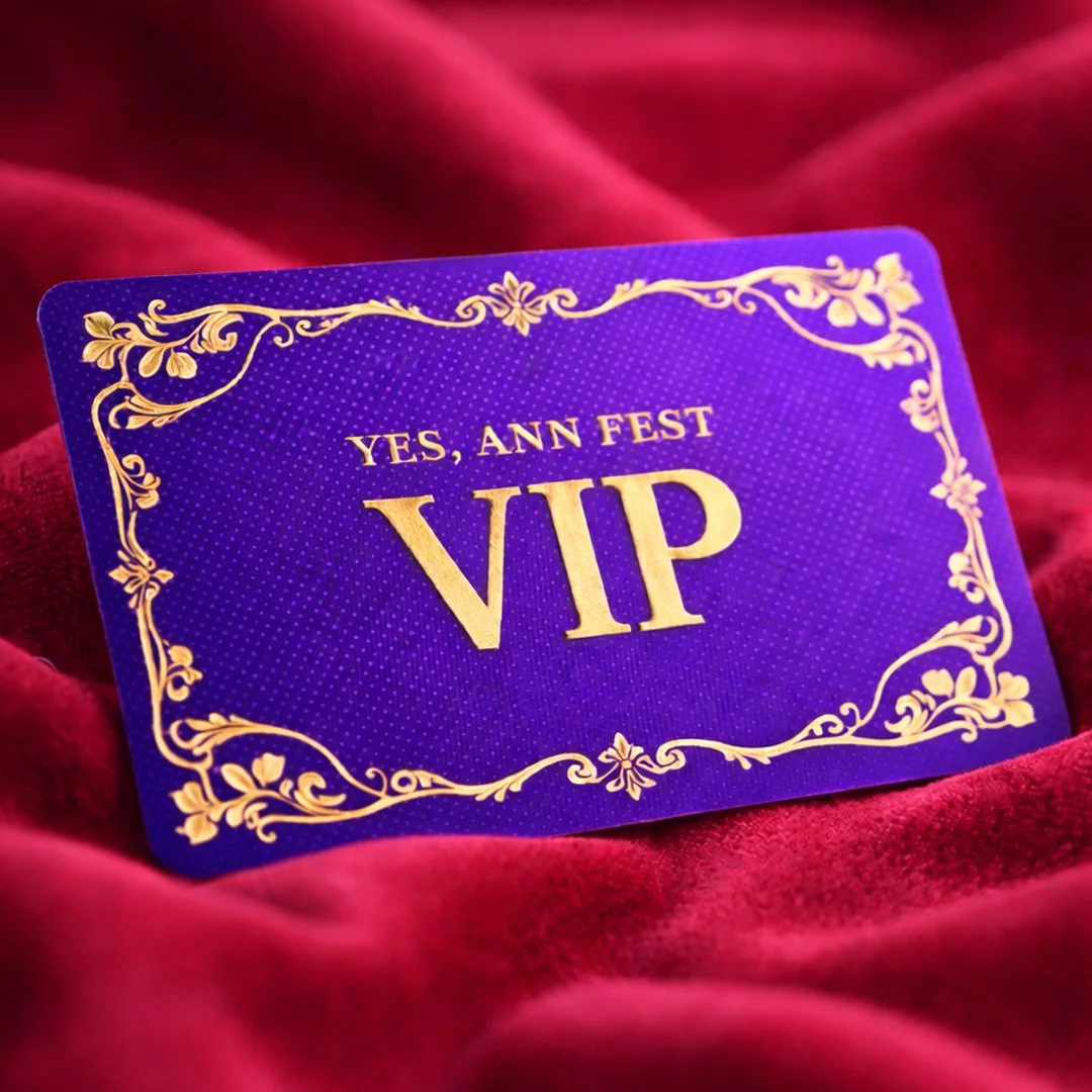 Purple VIP pass with gold decorative border and text that reads "YES, ANN FEST VIP" on a red velvet background.