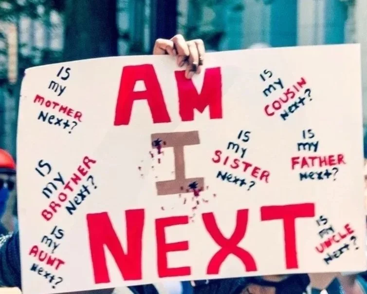 Image by Penn Today. "AM I NEXT" sign