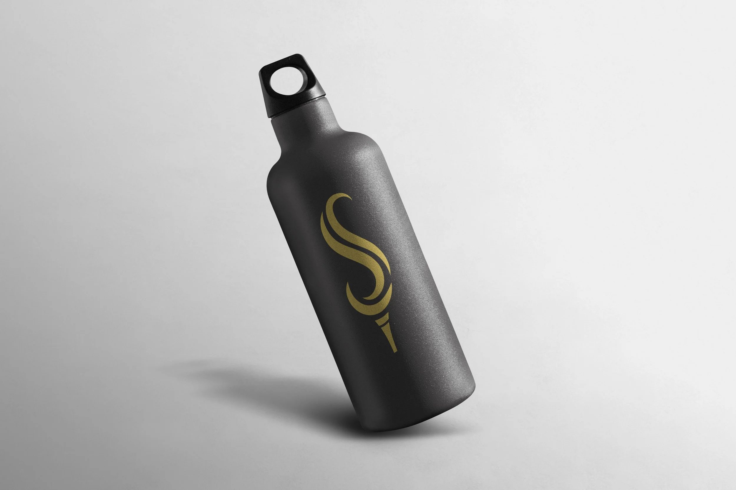 Black reusable water bottle with a gold stylized S-shaped logo on it, against a light gray background.