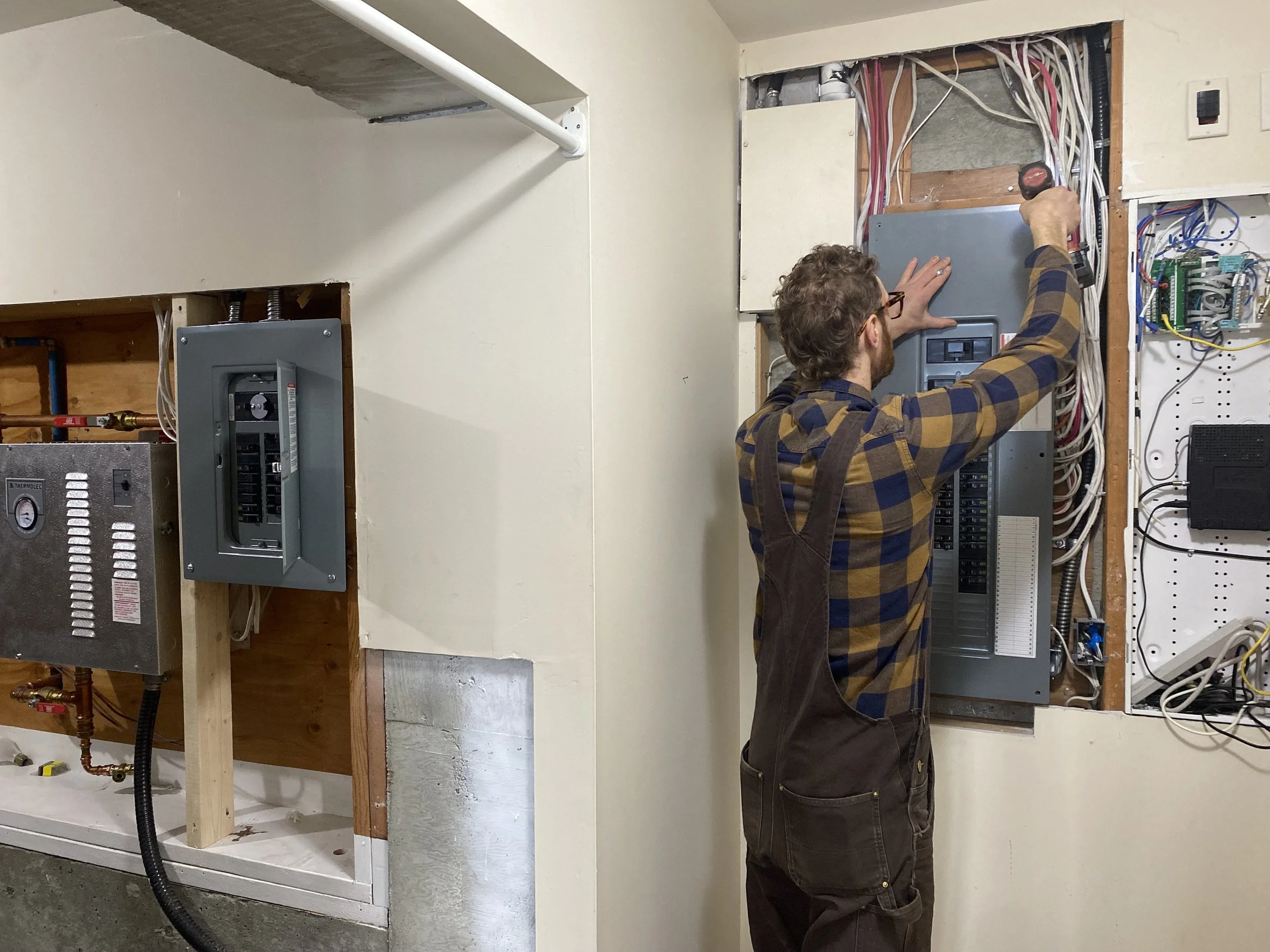 Oliver Hodswood of Suncycle Electric on Salt Spring Island servicing a commercial electrical breaker panel.