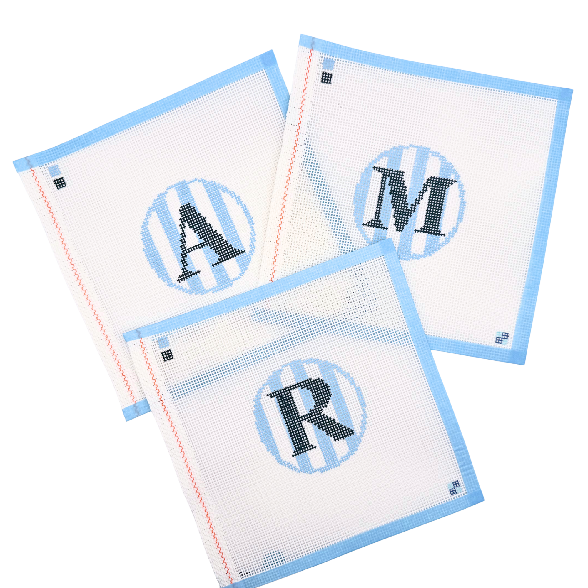 Hand-painted blue stripe letter A, R, & M needlepoint canvases from McCain Collective.