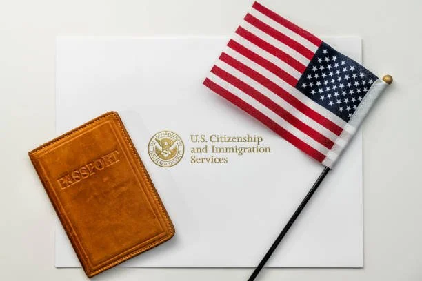 U.S. Citizenship and Immigration Services document with a small American flag, a brown leather passport holder, and a blank white background.