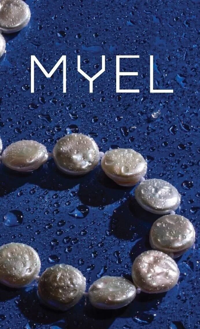 A blue surface with water droplets and white circular objects arranged in a heart shape, with the word 'MYEL' written in the center.