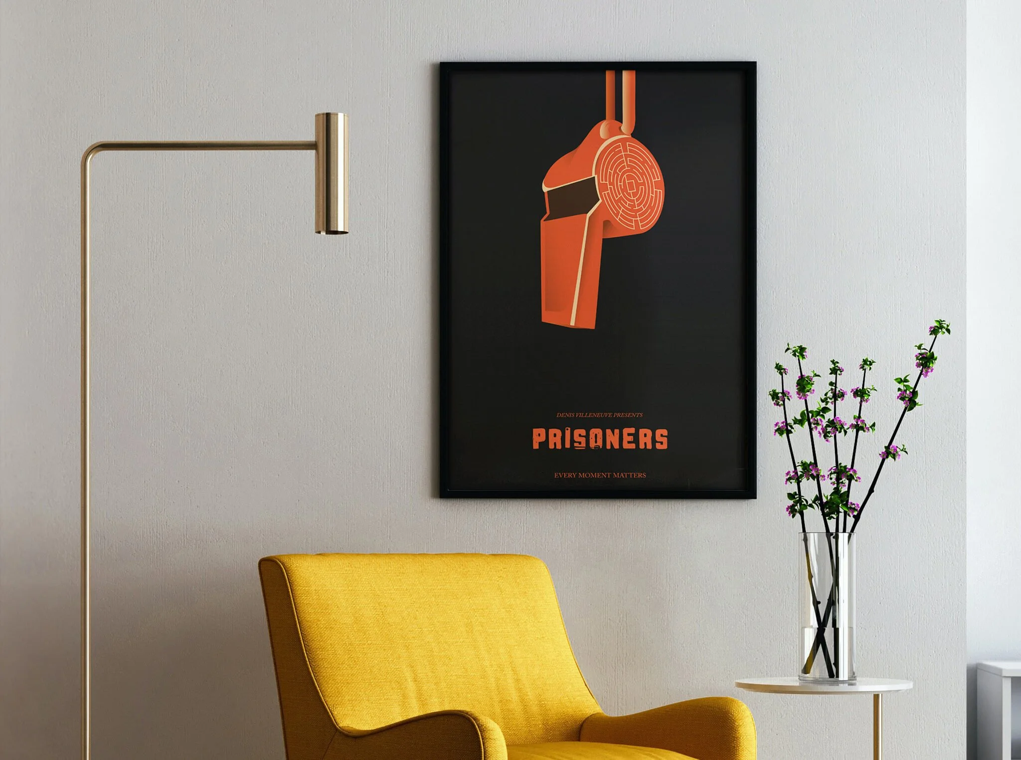 Decorative poster titled 'Prisoners' hanging on a white wall in a modern living space, with a yellow armchair, a tall gold floor lamp, and a vase with pink flowers on a small white table.