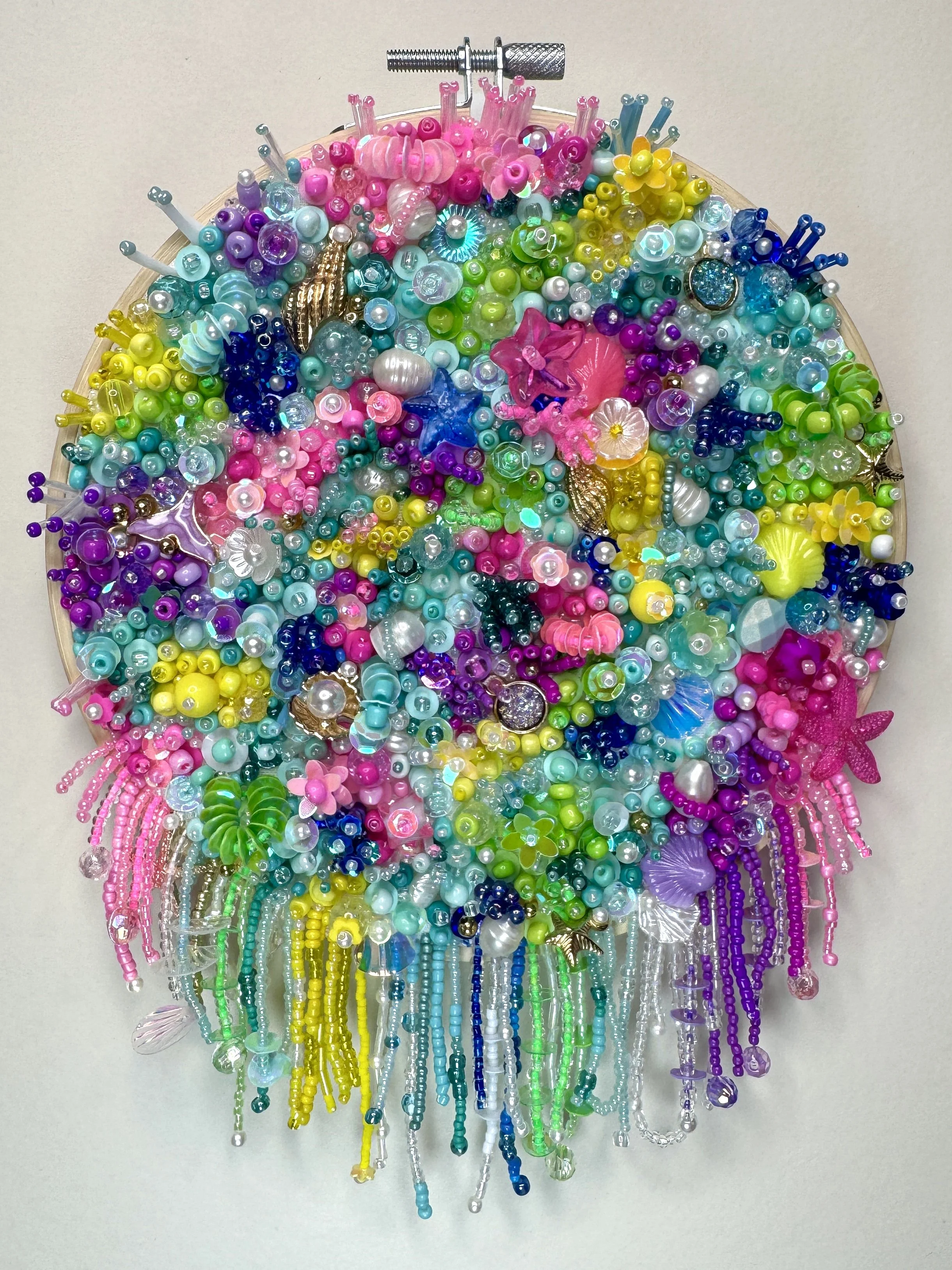Original contemporary embroidery artwork featuring vibrant beadwork inspired by underwater ecosystems by bead embroidery artist Kathleen Savanah.