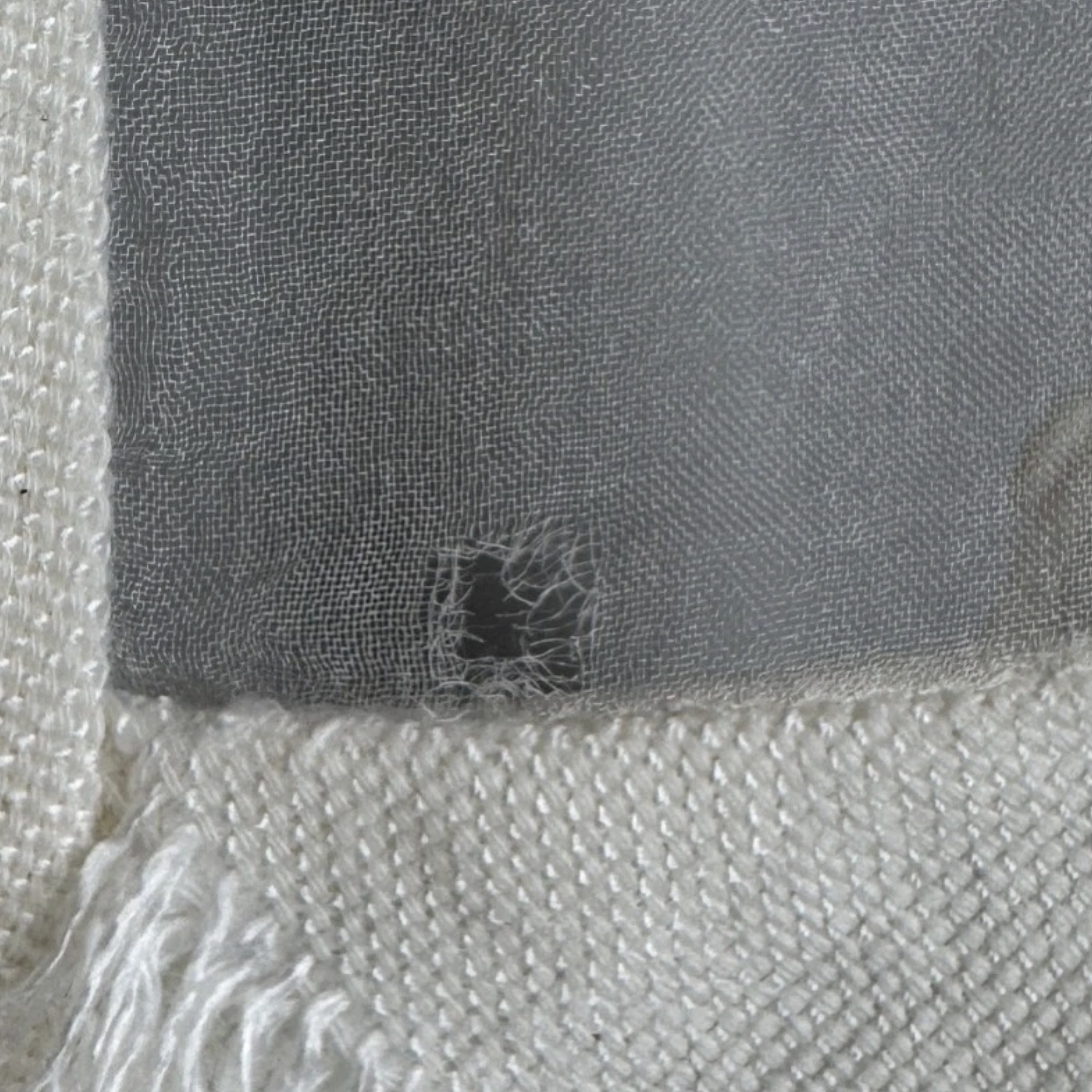 Hole in White Fabric