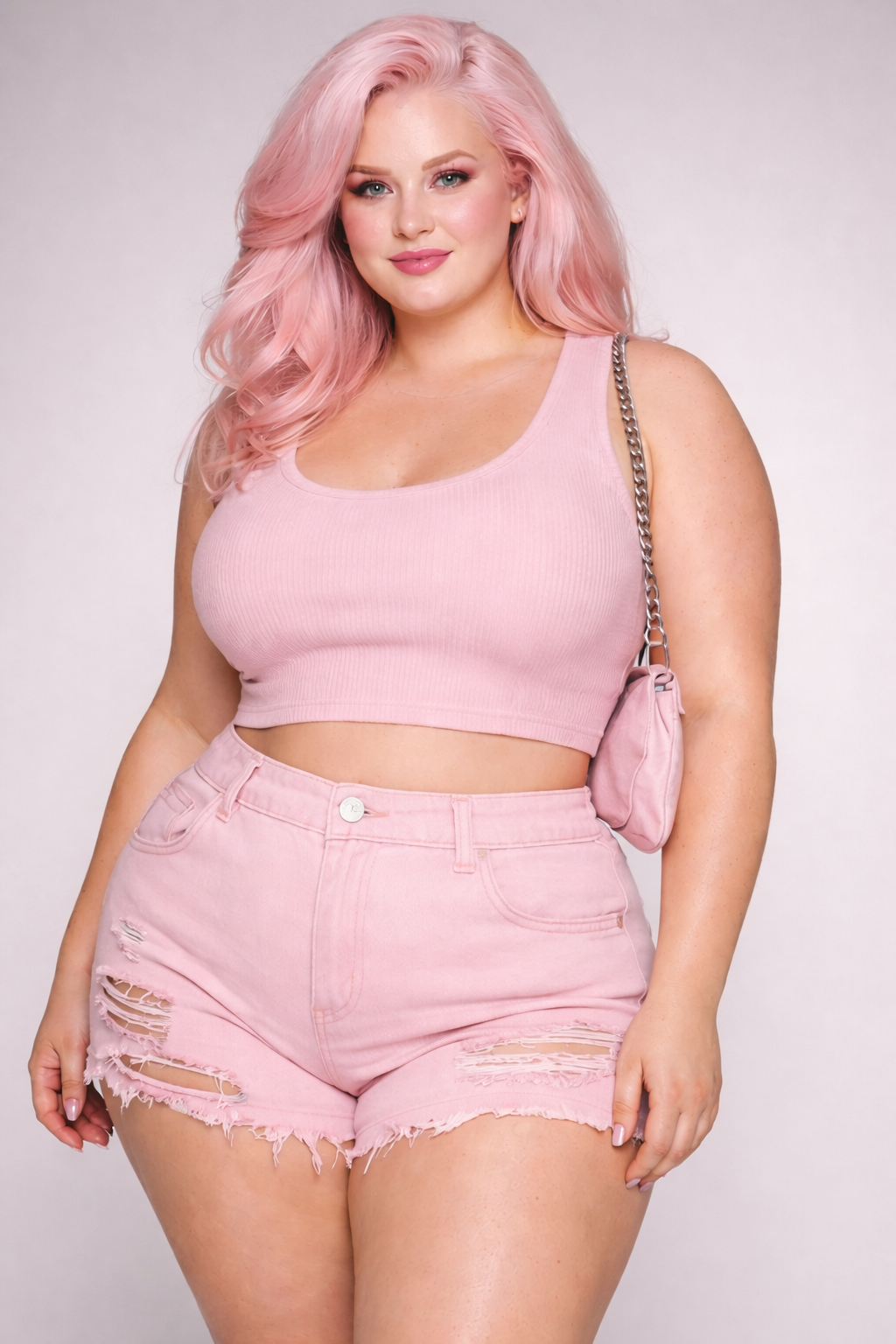 A woman with pink hair, wearing a pink sleeveless crop top and distressed pink denim shorts, holding a pink shoulder bag with a chain strap, standing against a plain background. Custom AI influencer, AI persona, AI brand ambassador.