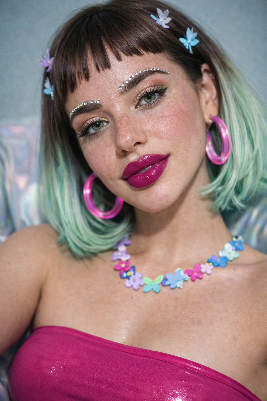 A woman with green eyes, pink lipstick, and makeup featuring rhinestones above her eyebrows. Custom AI model, AI influencer.