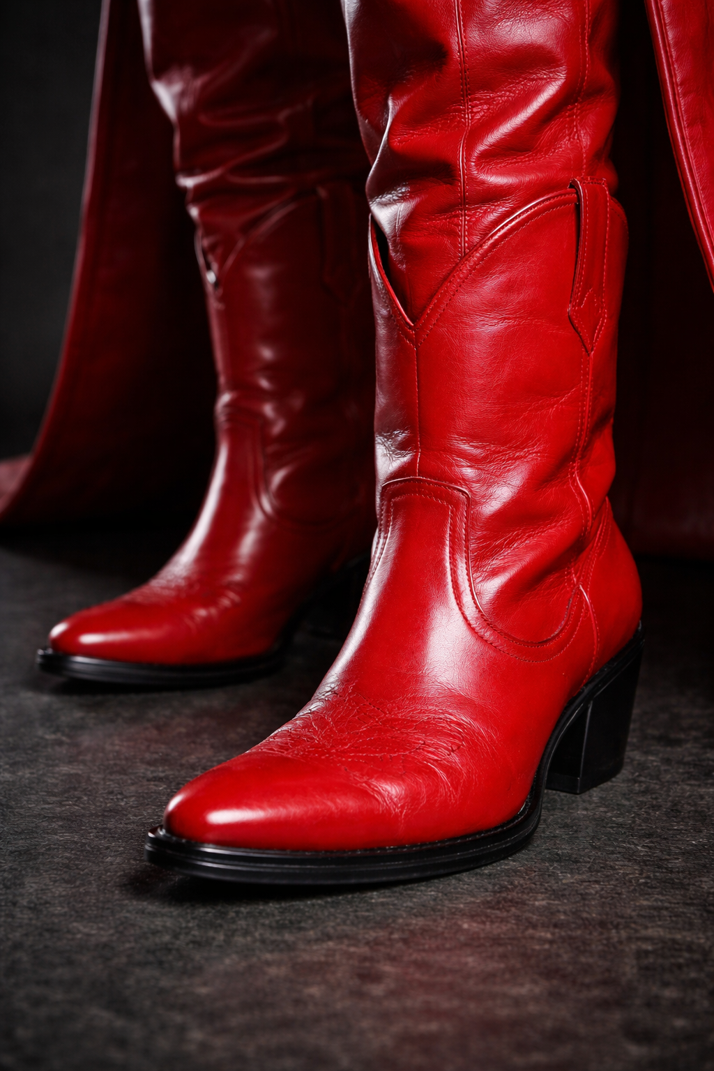 Close-up of shiny red leather cowboy boots with pointed toes and stacked heels. Custom AI influencer, custom AI content creator.