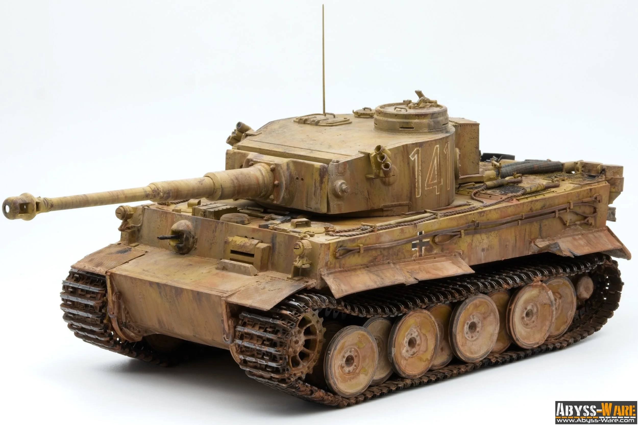 A detailed model of a military tank with a sandy camouflage paint, the number 14 on its turret, and various equipment attached, against a plain light background.
