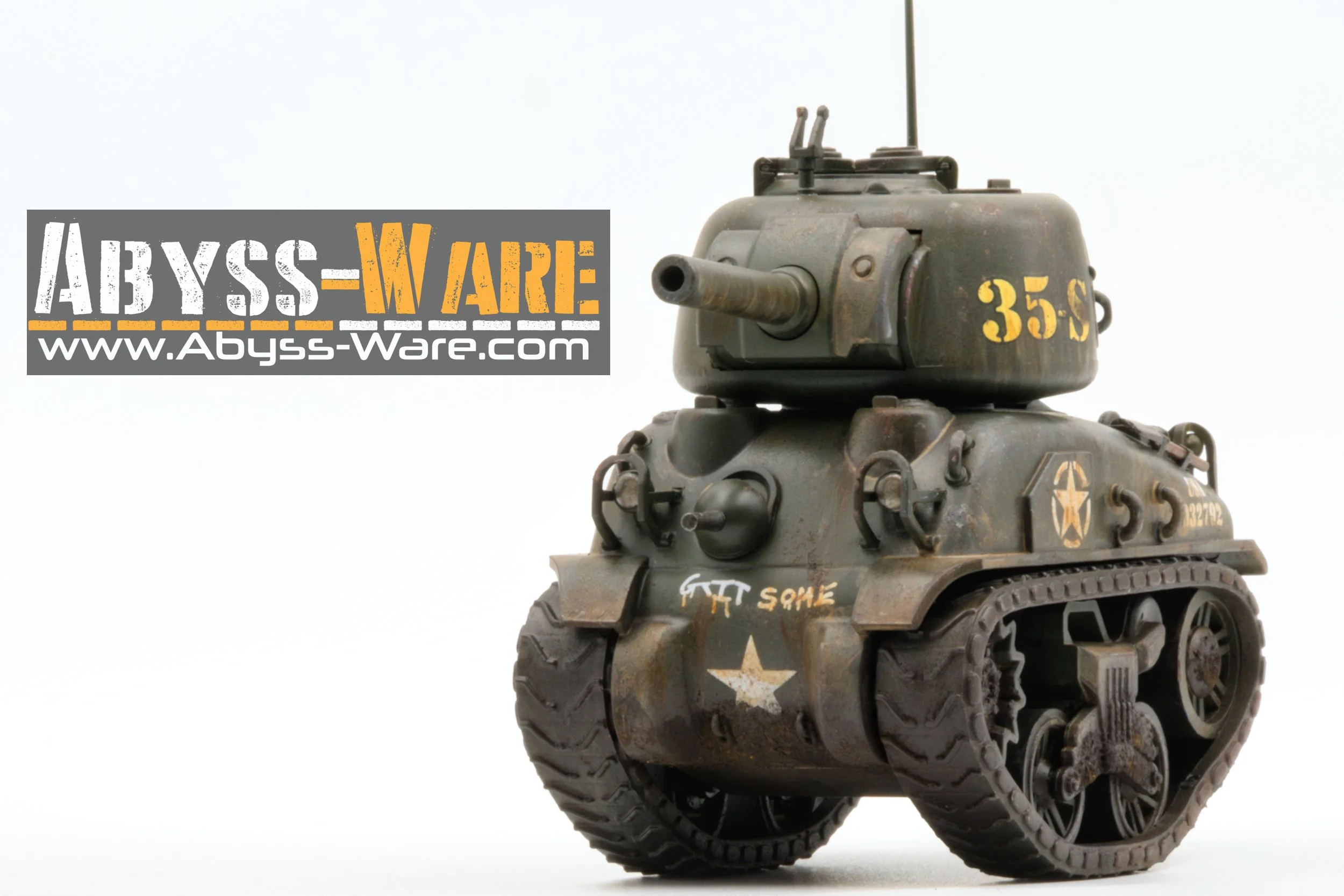 Miniature military tank with treads, weathered and painted in military green, with yellow markings and insignia. It is placed against a white background, with a logo and website for Abyss-Ware in the upper left corner.