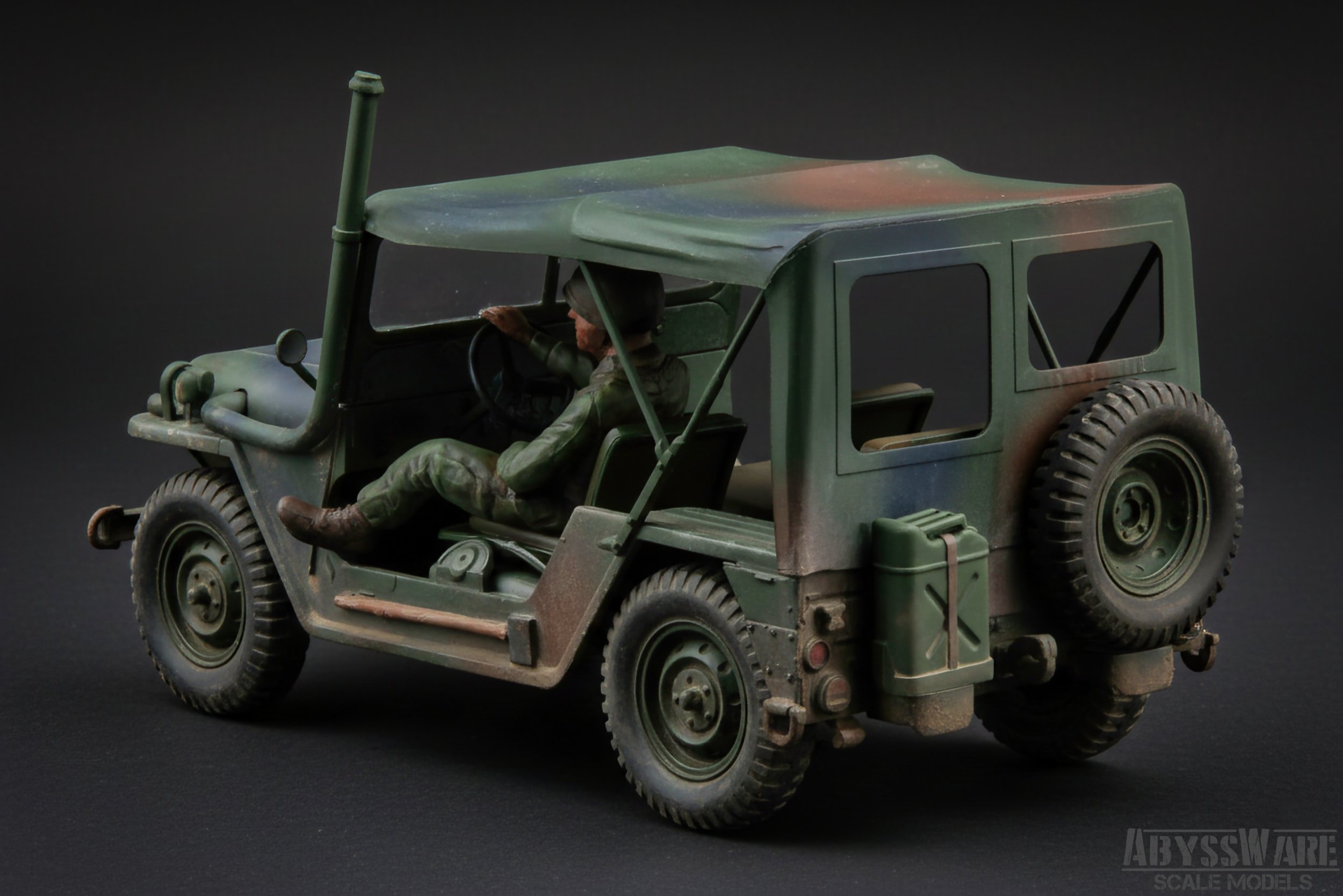 Model of a military jeep with a soldier figure inside, set against a black background.