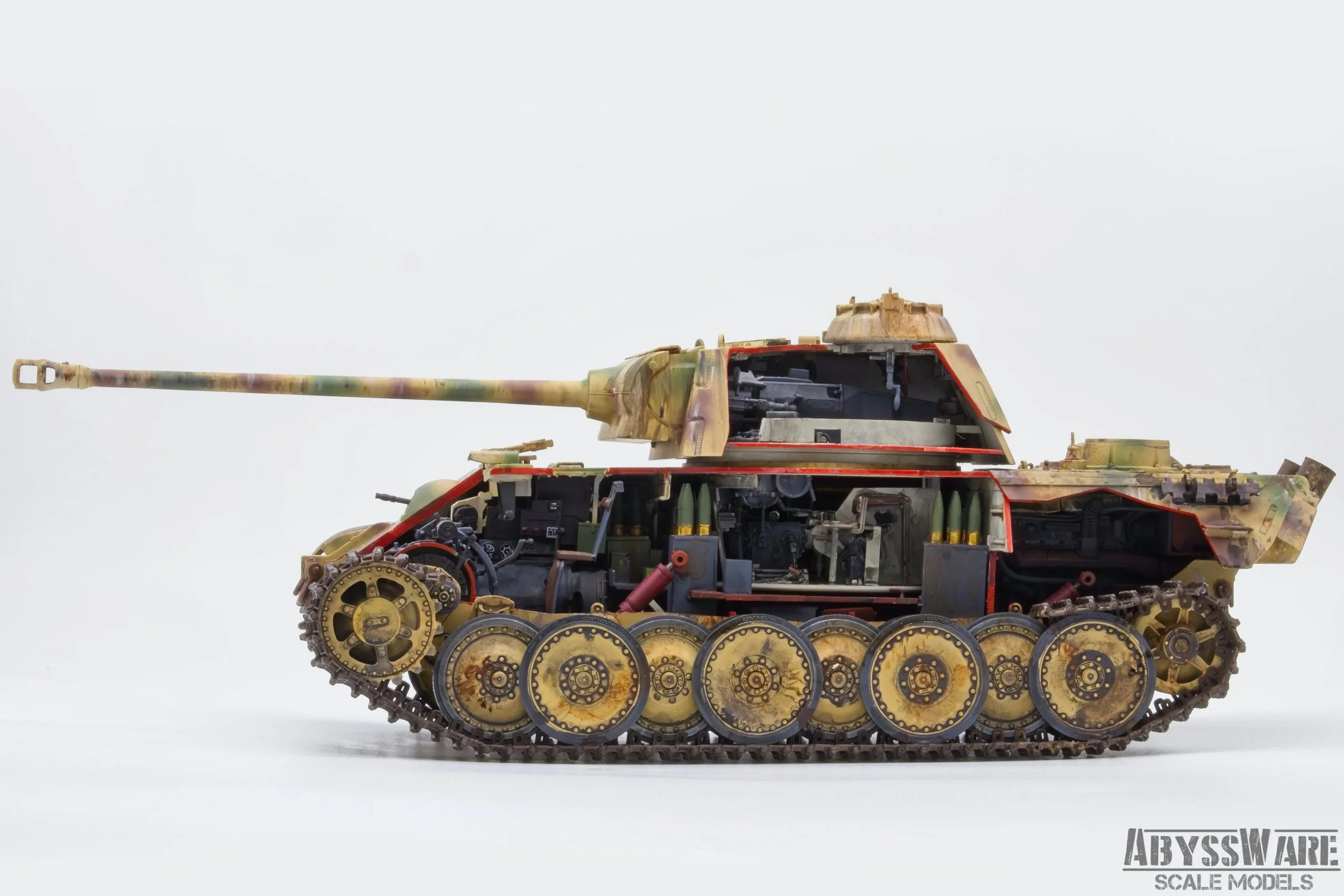 A detailed scale model of a military tank with camouflage paint, showing its interior components and tracks, against a plain white background.