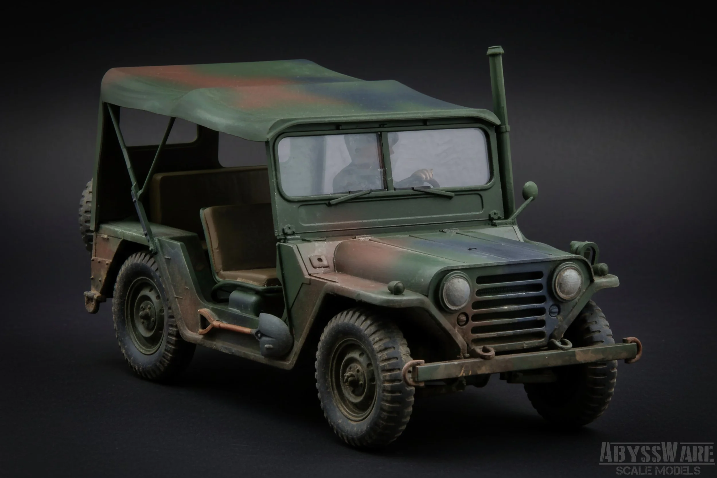 A detailed scale model of a vintage military jeep with a green and brown camouflage paint job, black tires, and a beige interior, positioned on a black background.