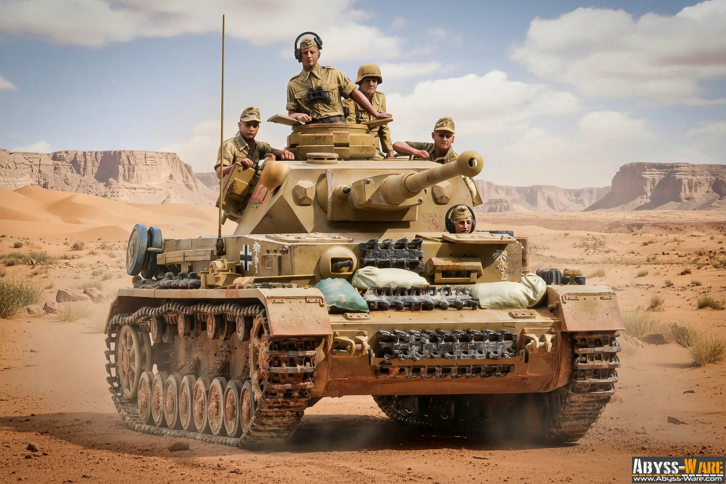 A military tank moving across a desert landscape with sand dunes and rock formations in the background. Several soldiers are on and around the tank, some with helmets and headphones, in a dry, sunny environment.