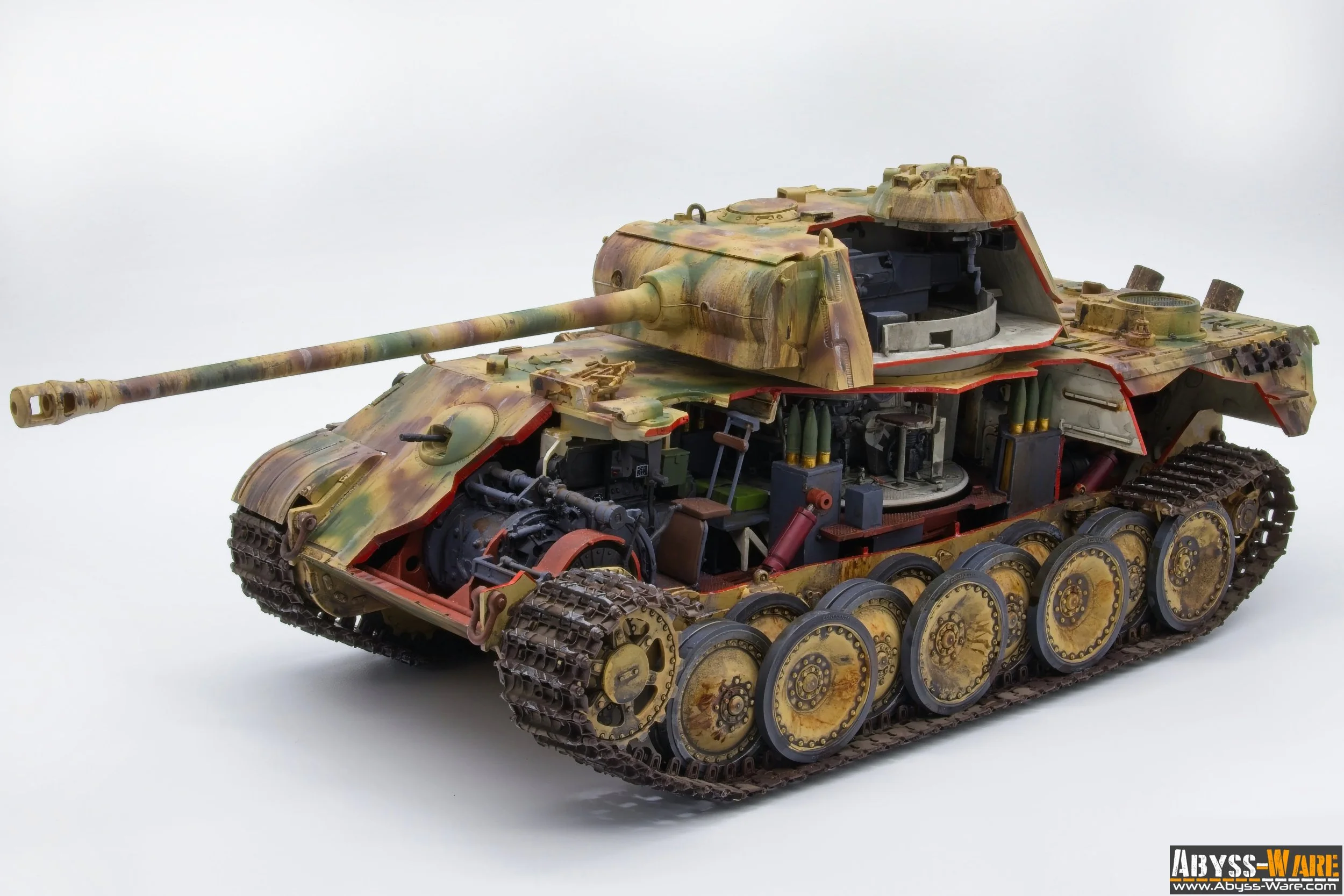 Detailed scale model of a military tank with camouflage paint, partially disassembled, showing internal components and tracks against a plain white background.
