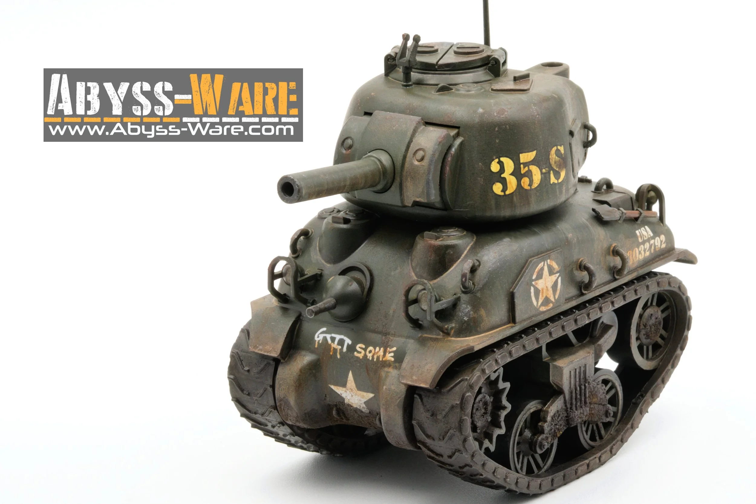 A detailed model of a military tank with a weathered, dark green paint job, markings including '355 S' and a star emblem, and a small sign in the top left corner reading 'Abyss-Ware' with a website URL.