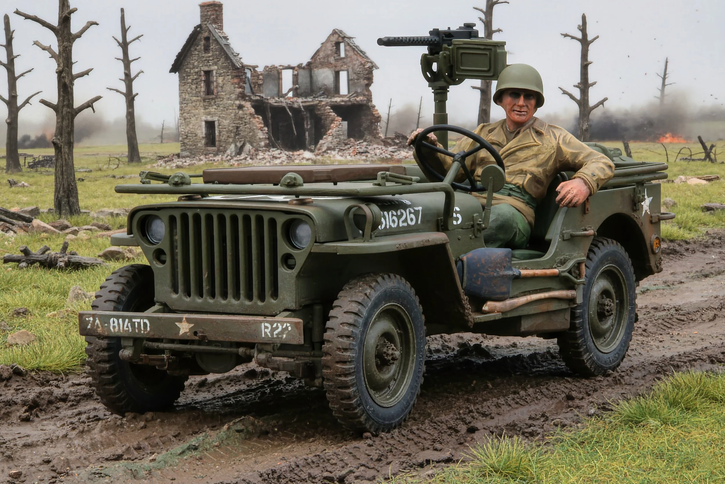 A soldier in WWII uniform sitting in a military Jeep on a muddy road with a burned-out building and leafless trees in the background.