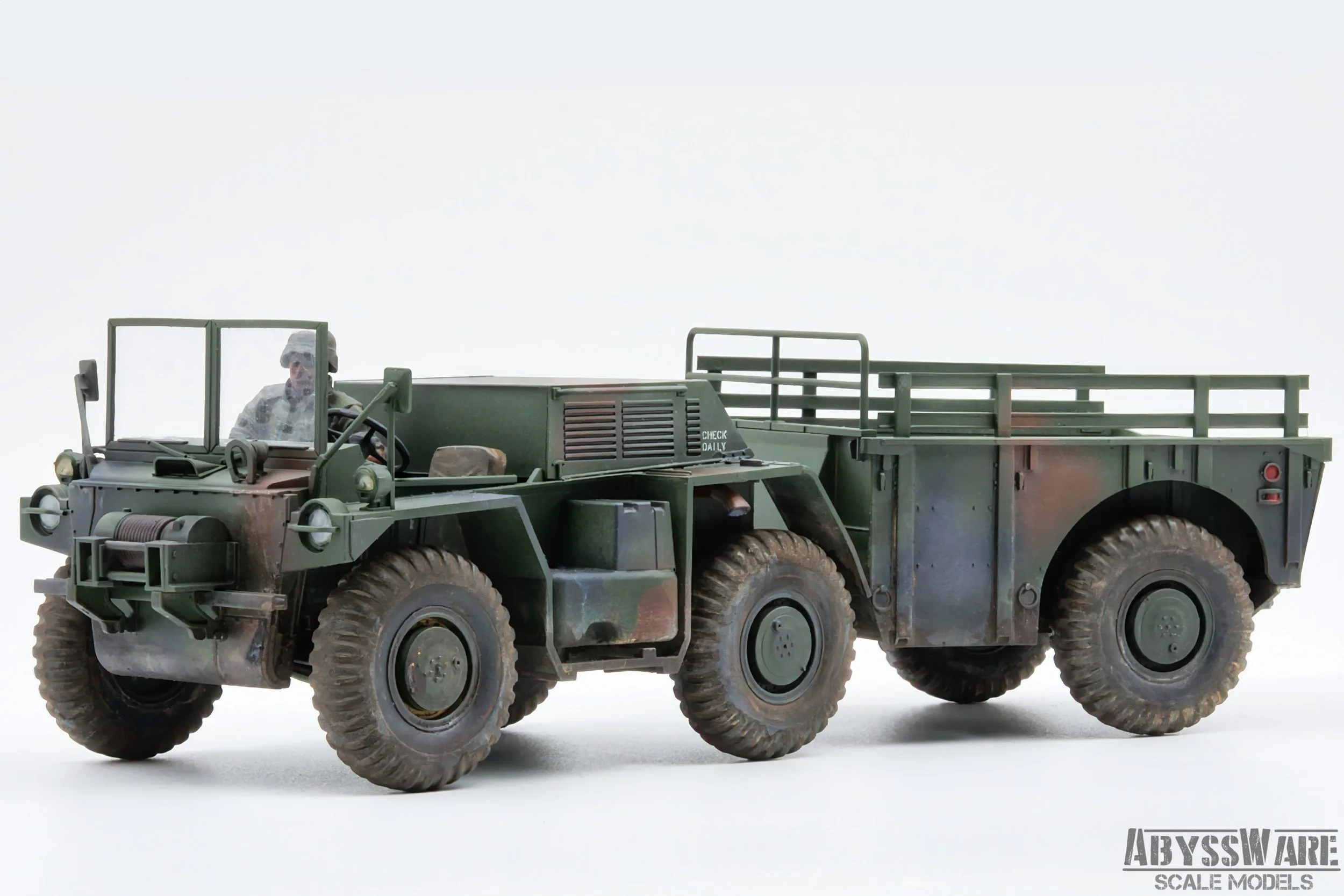 Model military truck in green with a driver figure, detailed wheels, and a cargo area at the back, labeled 'Abyssware Scale Models'.