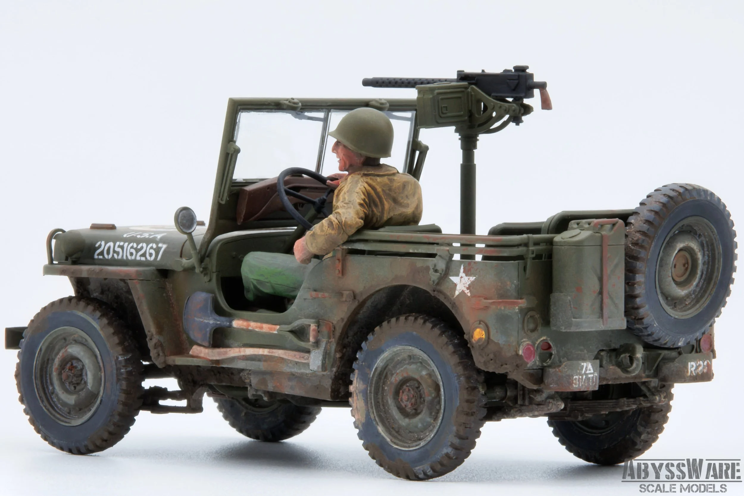Scale model of a military jeep with a soldier figure, mounted machine gun, and camouflage paint, displayed on a white background.