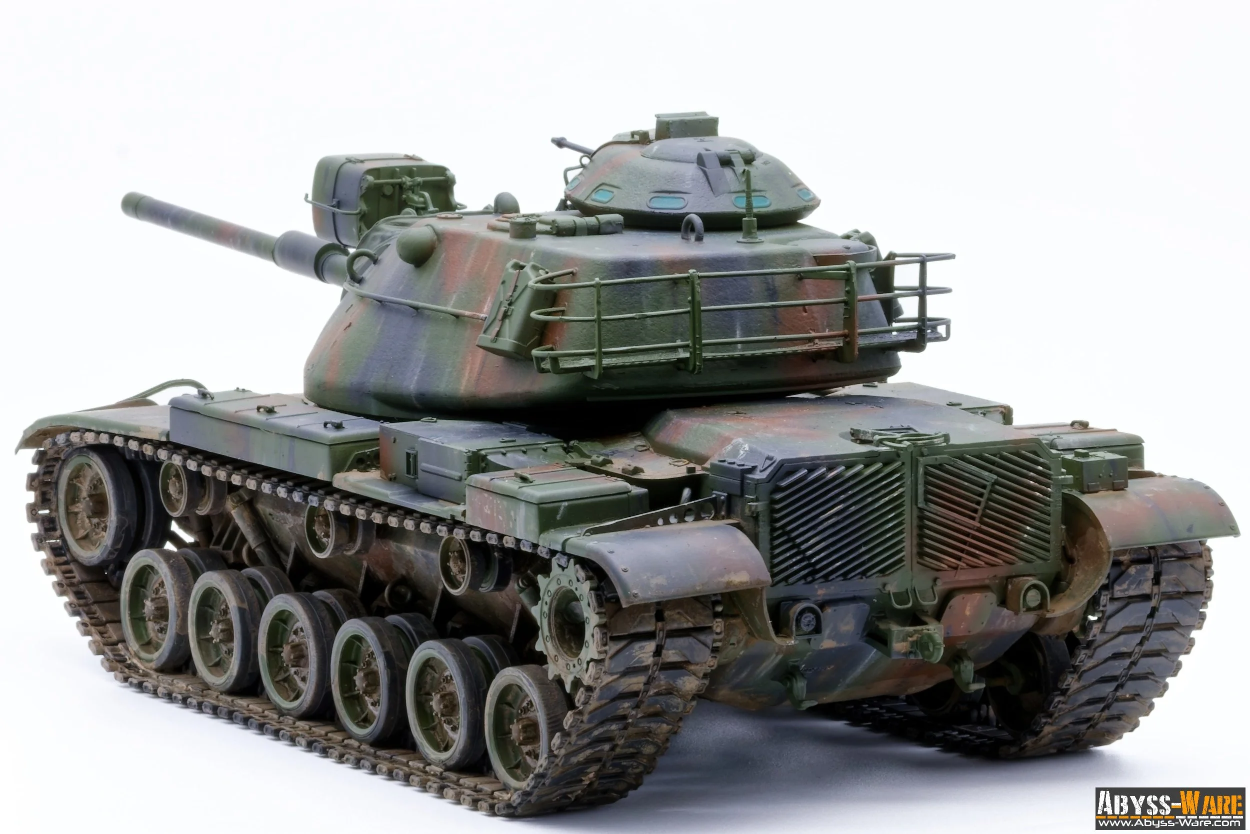 Model of a military tank with green camouflage, featuring a large gun barrel, turret, tracks, and various detailed components.