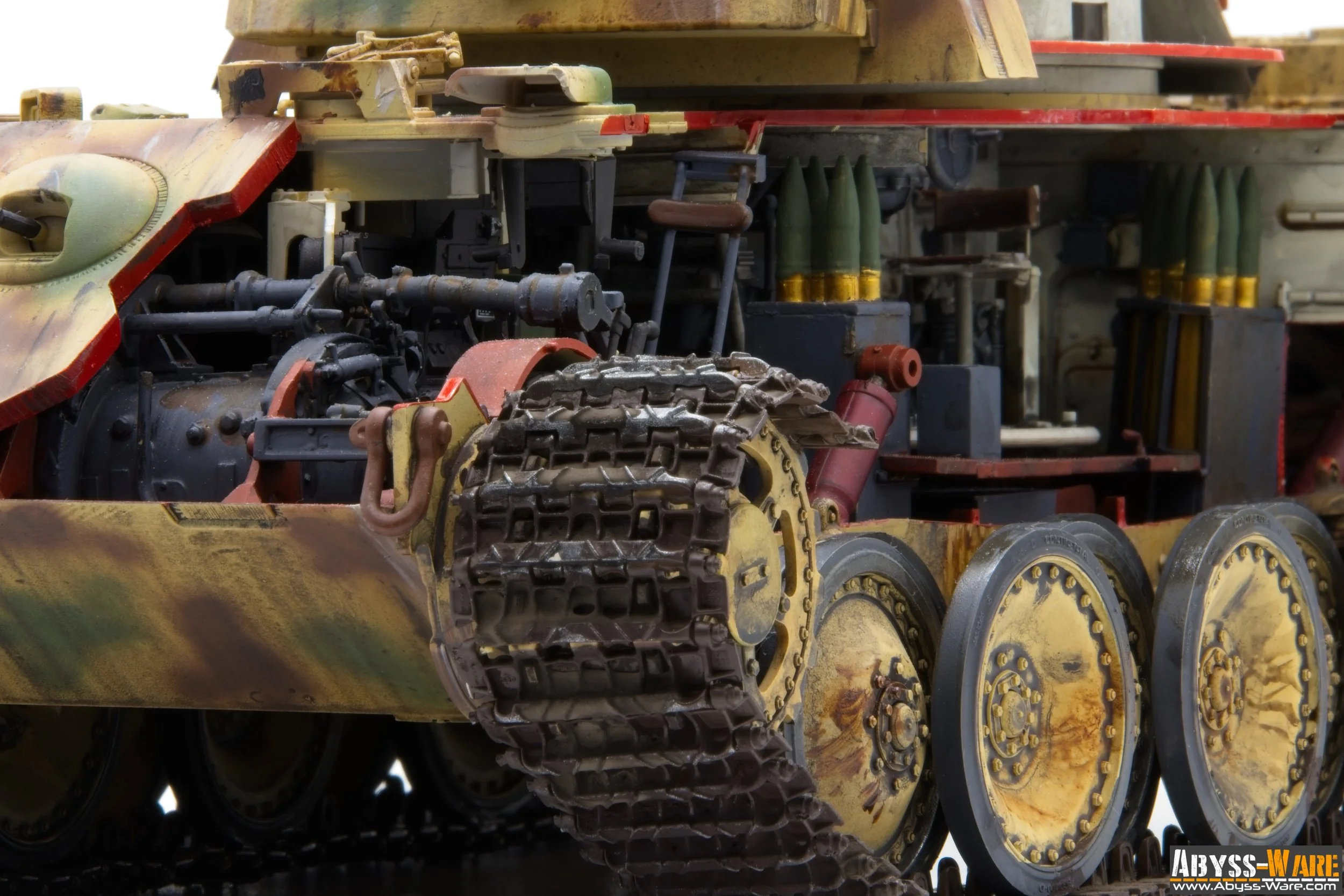 Close-up of a weathered military tank, showing parts of its tracks, wheels, and interior components with visible wear and rust.