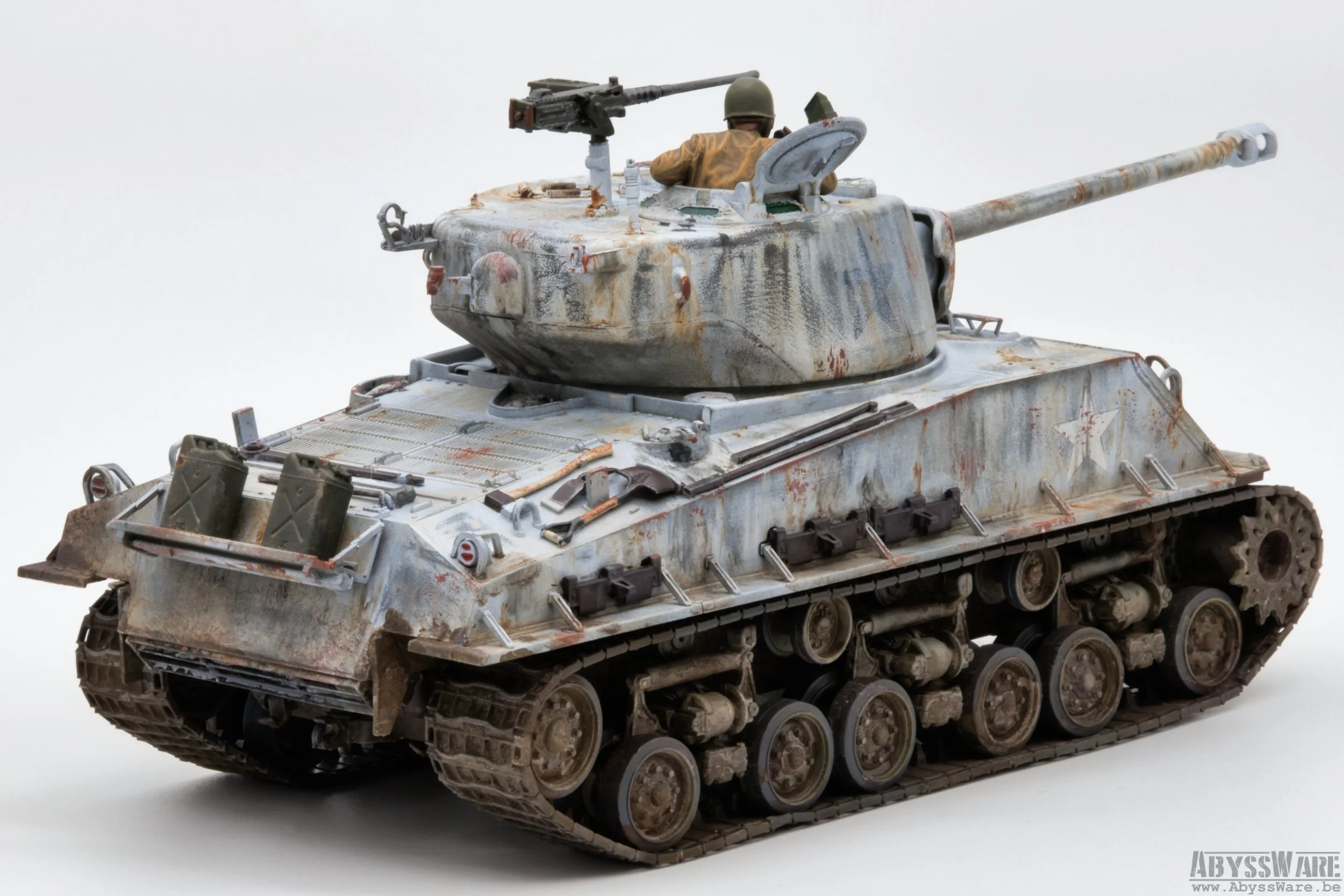 A detailed model of a military tank with a weathered, rusty appearance, featuring a small soldier figure in the turret, against a plain white background.
