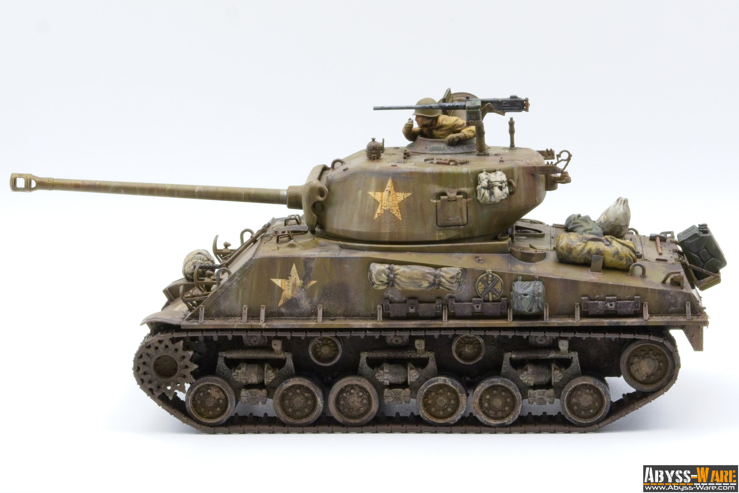 Model of a military tank with weathered details, military markings, and a detailed figure inside the turret.