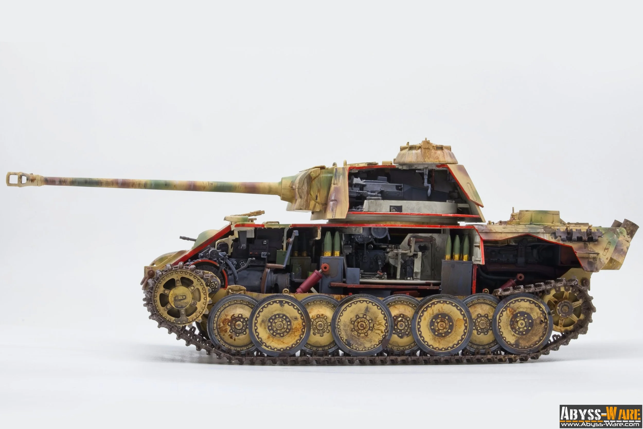 Close-up of a detailed model tank with military camouflage colors, showing internal components and mechanical parts inside the body, against a plain white background.