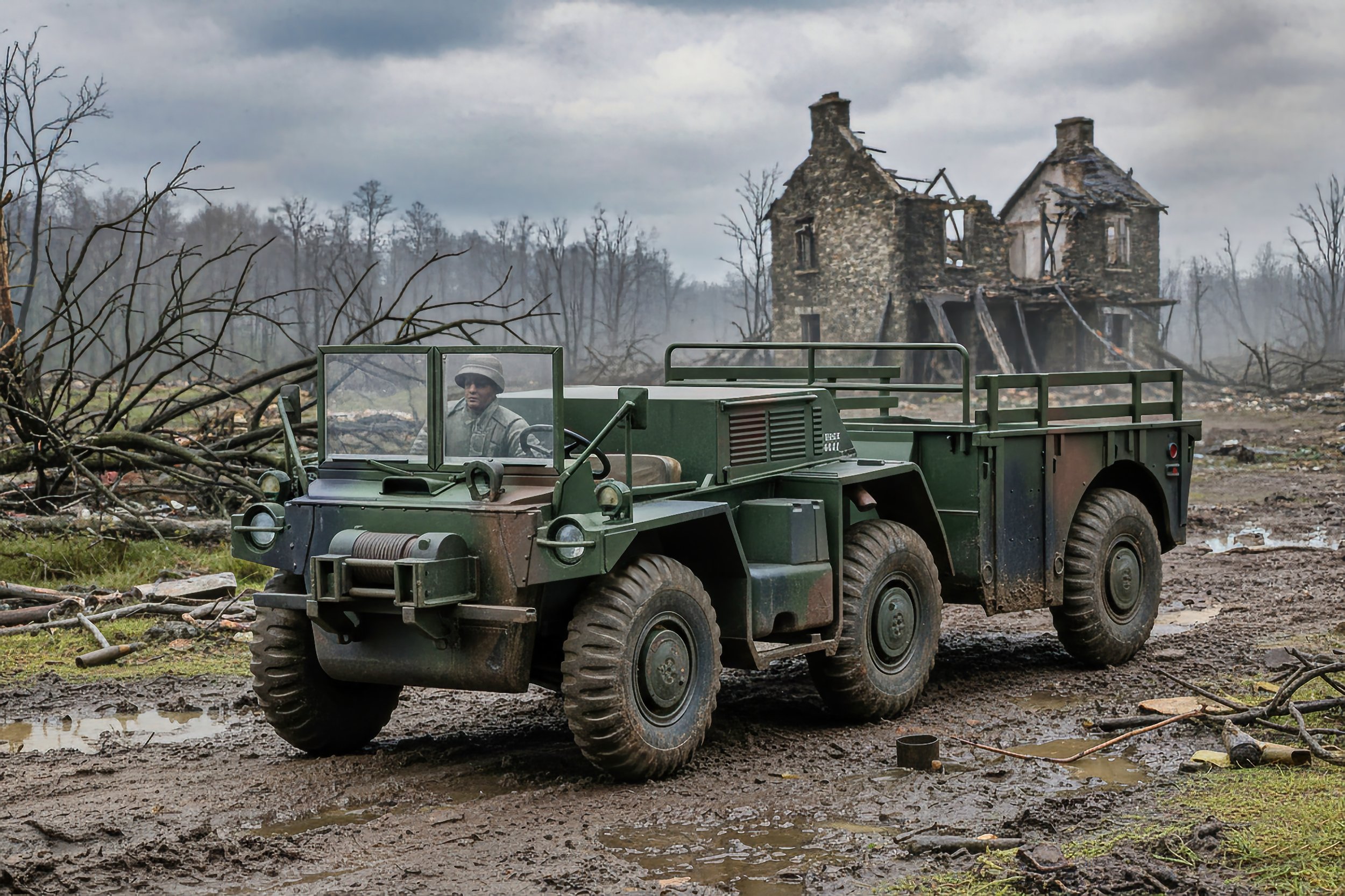 A military vehicle driving through a muddy battlefield with a damaged house in the background and fallen trees.