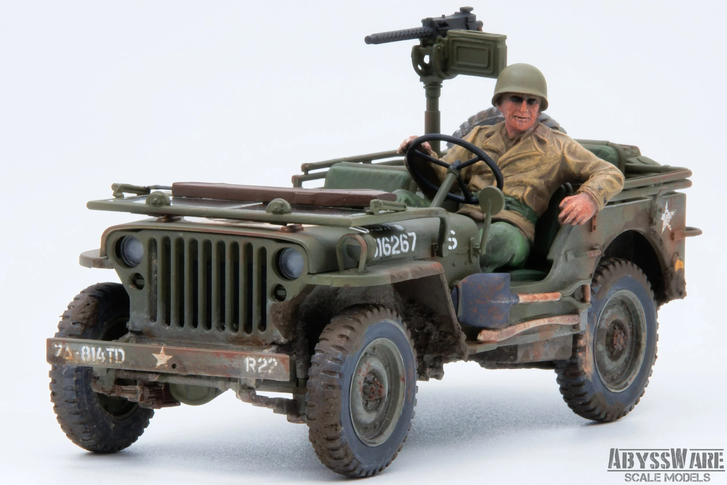 Scale model of a World War II military Jeep with a soldier figure wearing military uniform and helmet next to a mounted machine gun, set against a plain white background.